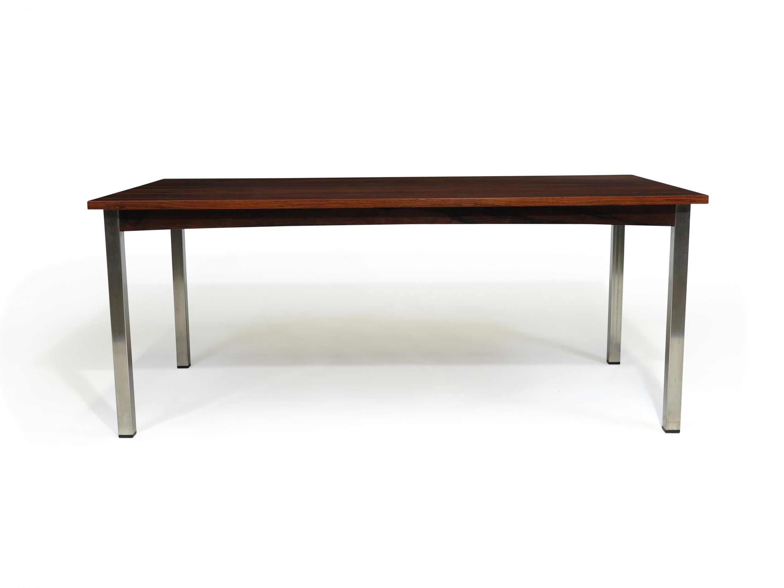 Midcentury rosewood coffee table circa 1970s Denmark. The coffee table crafted of book match rosewood veneer over solid wood core raised in metal legs.