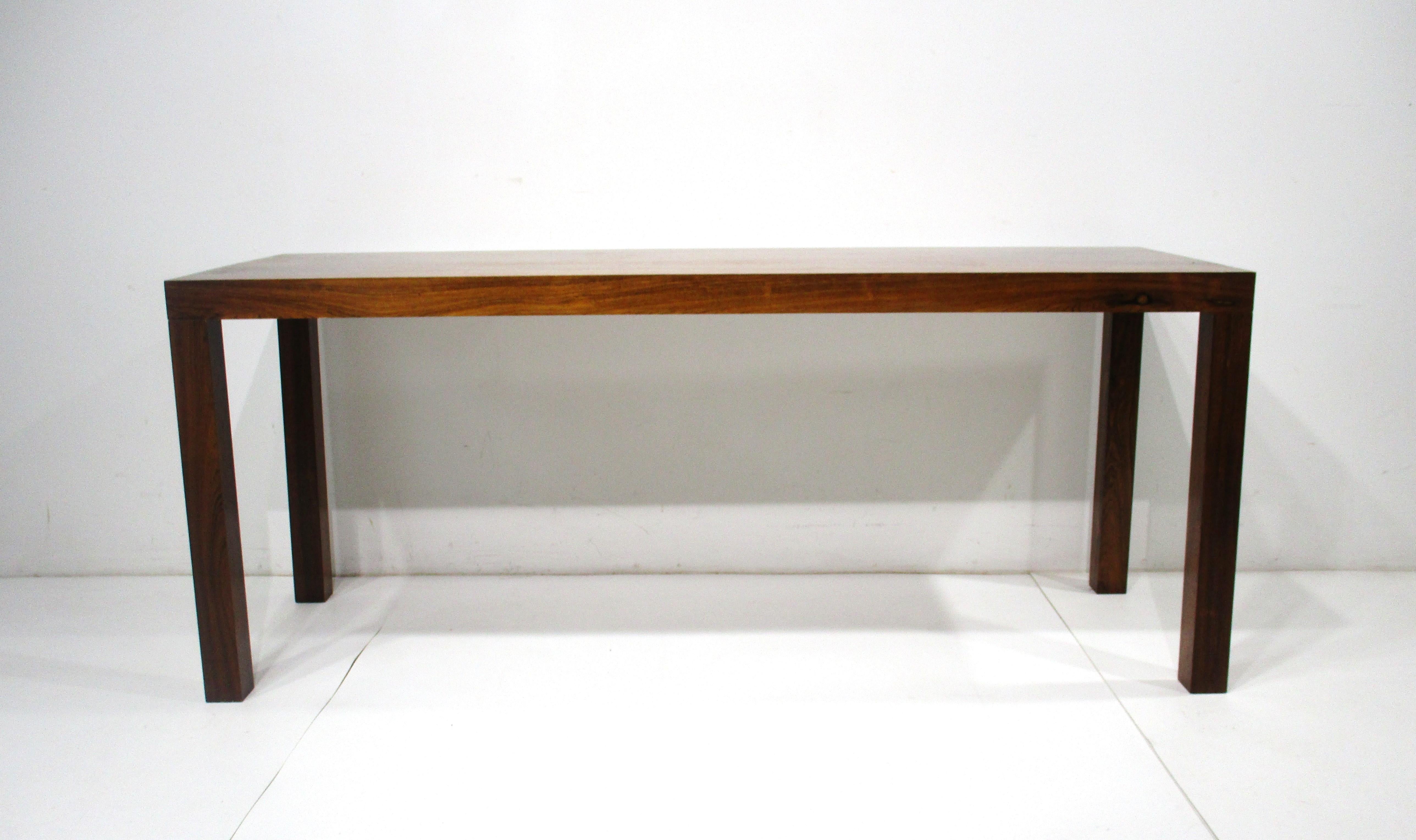 A very well grained and quite impressive dark Brazilian rosewood parson styled console table . Still retains the original label cafted by Centrum Mobler in Denmark and designed by Hom Ringsted . A great piece for that entrance way , behind a sofa or