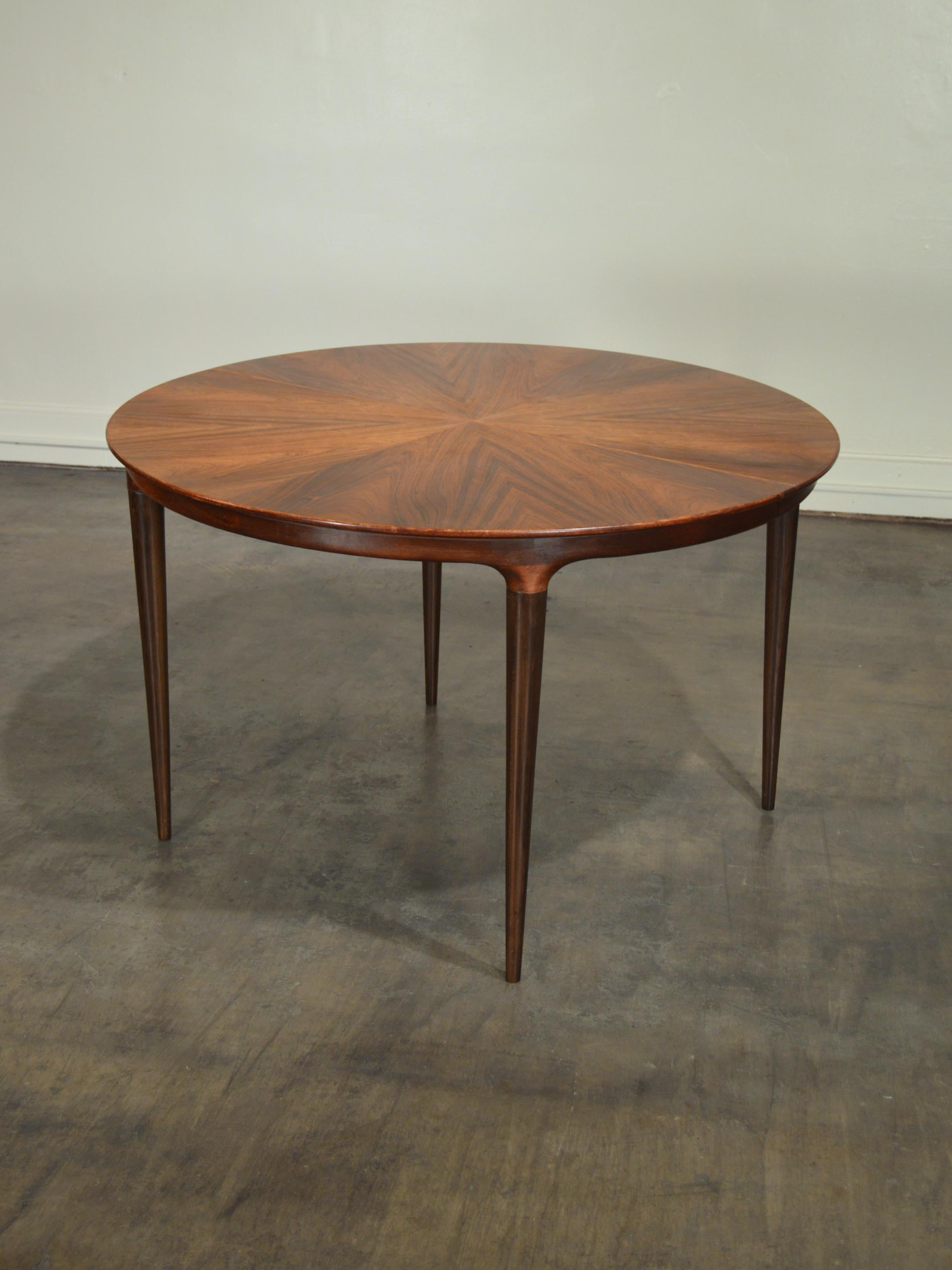 Brilliant Rosewood Cortina expanding dining table designed by Svante Skogh for Seffle Mobelfabrik of Sweden circa 1960. Table sits atop elegantly turned legs, appearing to nearly float off the floor. This uncommon design features a unique and