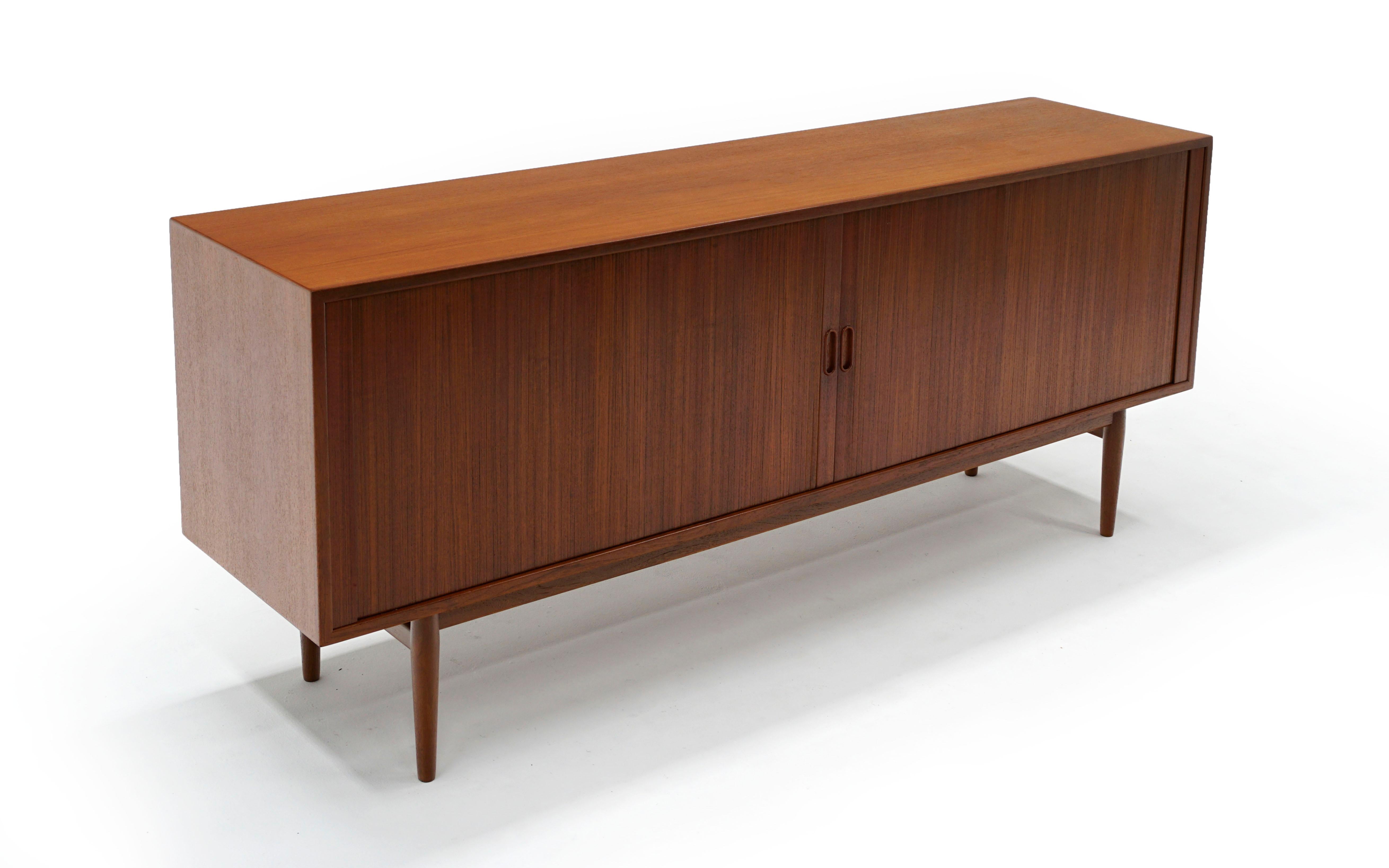 Brazilian rosewood Danish modern sideboard / credenza / media cabinet designed by Arne Vodder for Sibast. Expertly restored and refinished, ready to use. The doors slide open and disappear into the cabinet. The craftsmanship is such that it almost