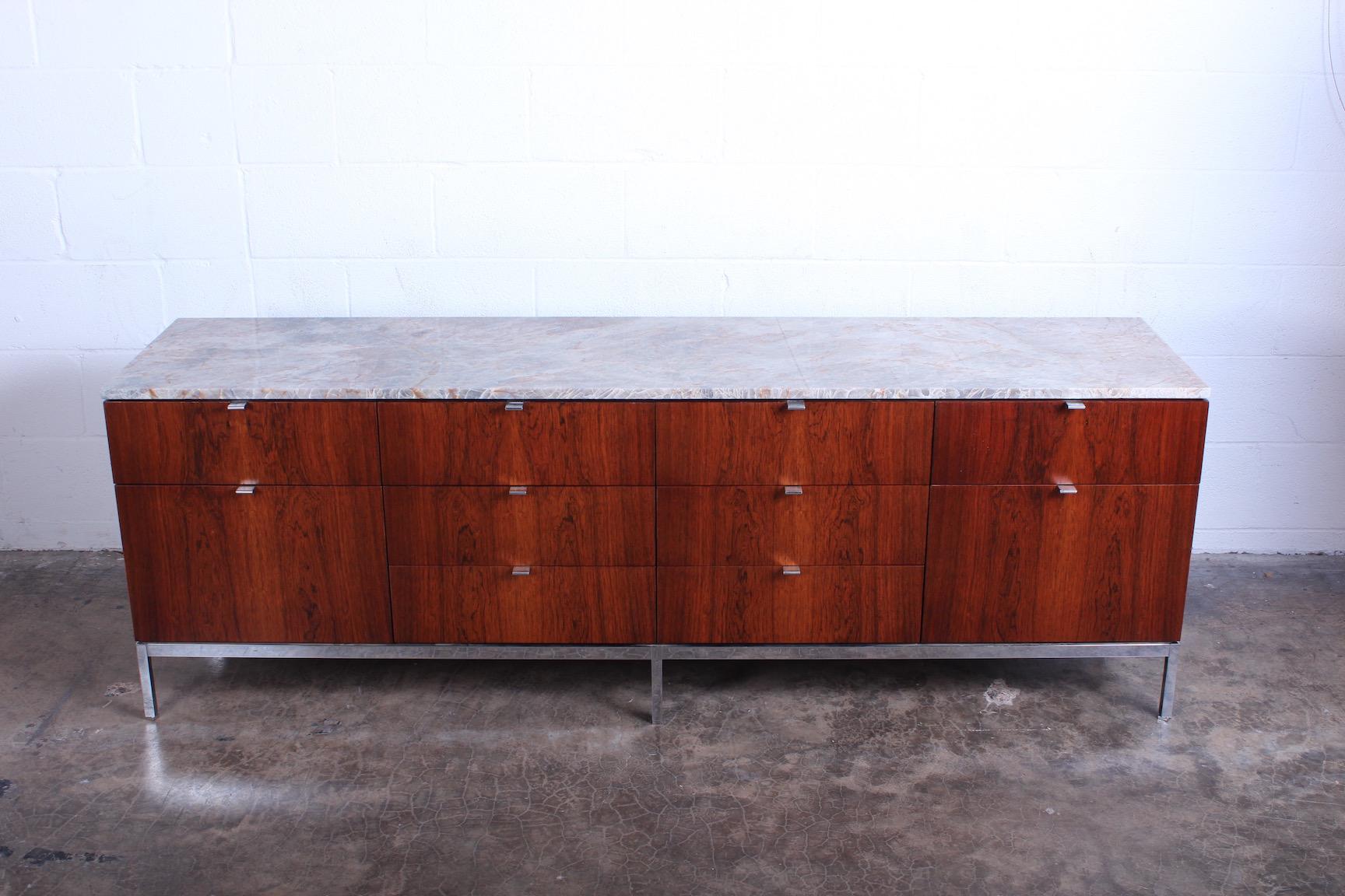 Florence Knoll rosewood credenza with chrome base and stone top.