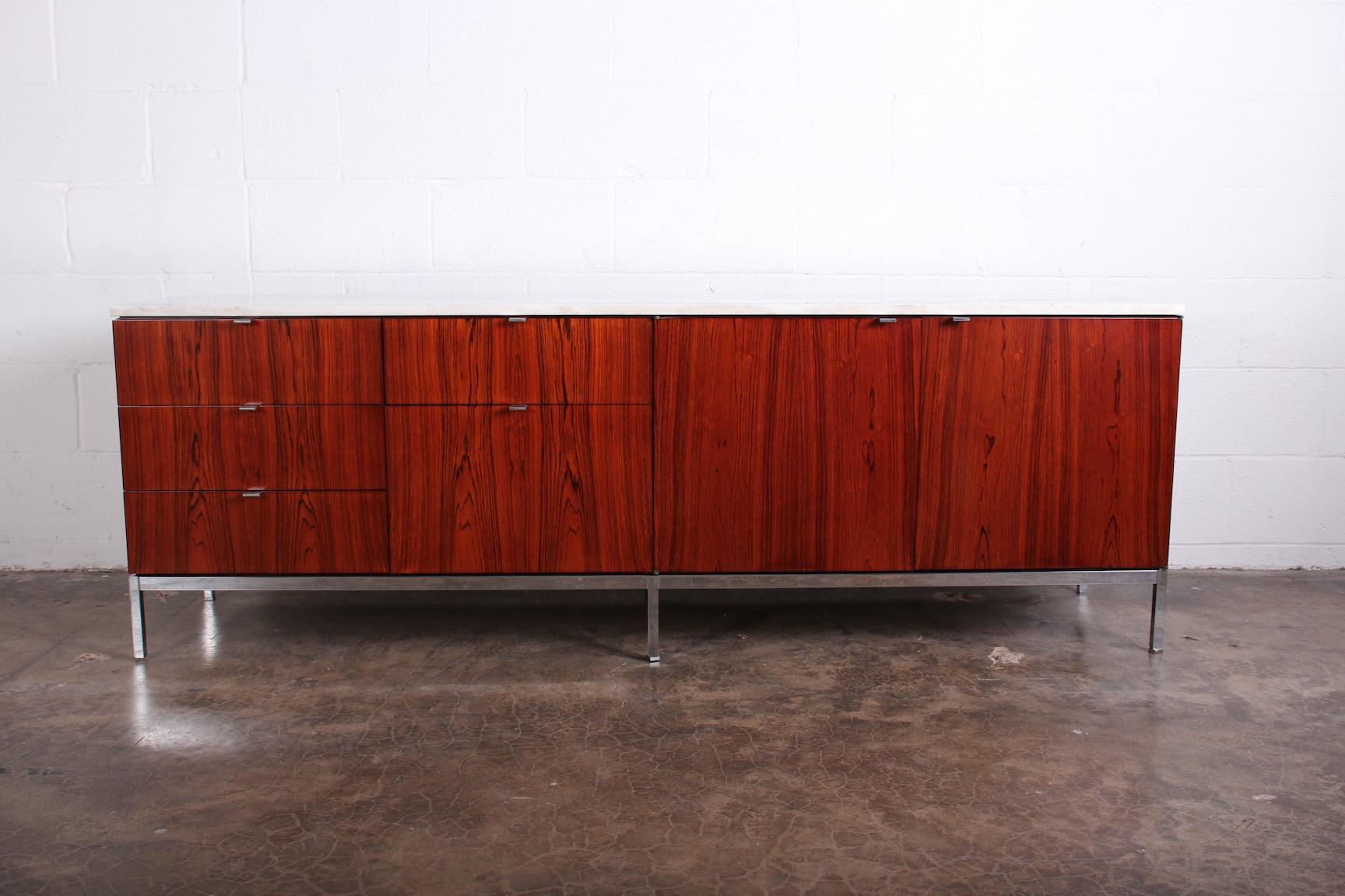 Florence Knoll rosewood credenza with chrome base and stone top.