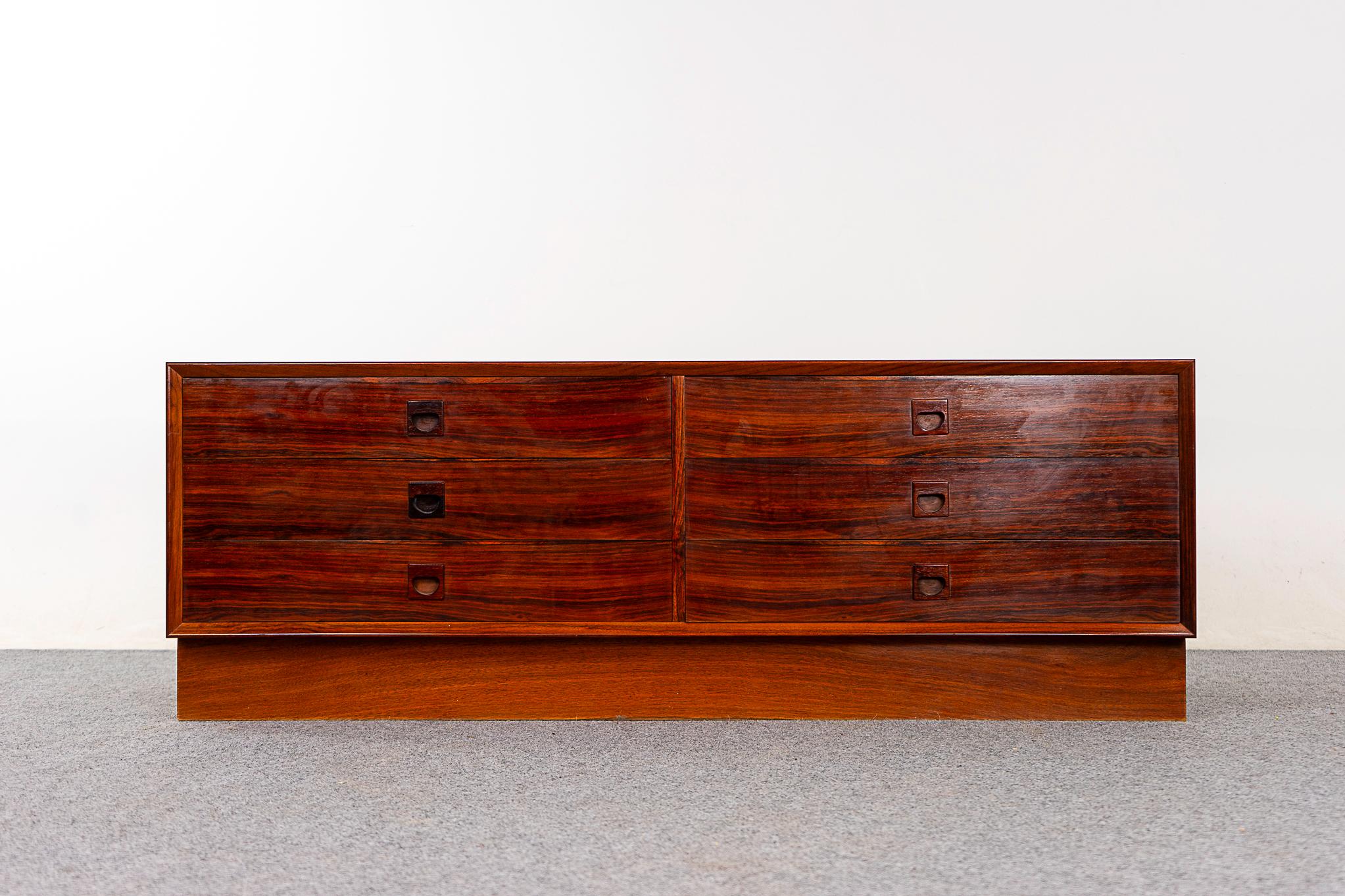 Rosewood mid-century dresser, circa 1960's. Great grain patterns, solid wood edging and book-matched veneer flat surfaces. Sleek handles and robust construction. Long, low proportions allow you to hang a flat screen TV above!

Unrestored item with