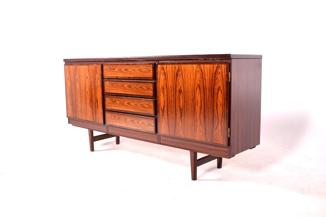 Danish rosewood cabinet sideboard by Scan-Flex made in Denmark. Label is seen on the back. The central section has drawers along with the two side cupboards giving ample storage.