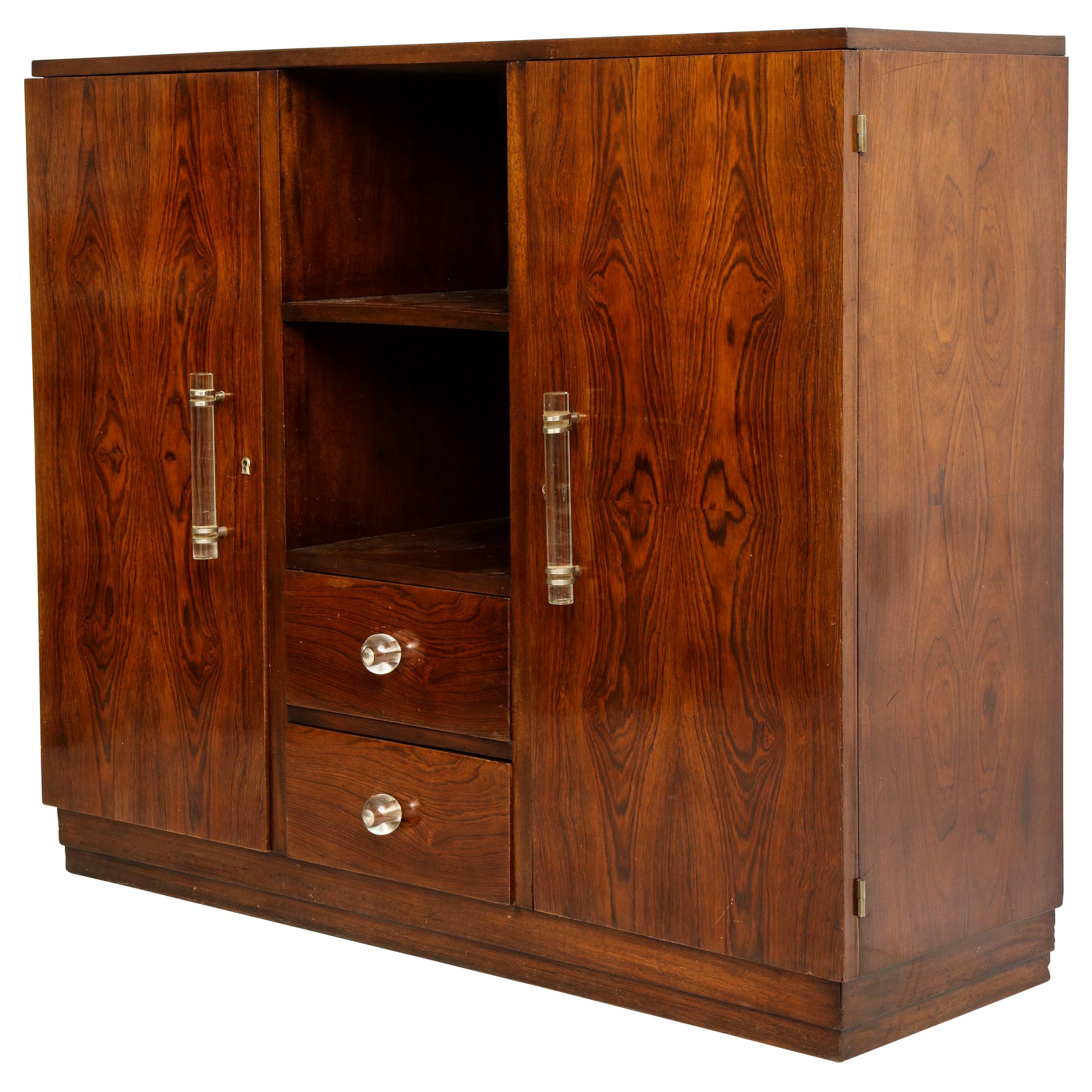 Rosewood, deco cabinet with glass handles in the style of Jacques Adnet, France, 1940. 

Handsome solid rosewood cabinet in lovely vintage condition. Similar to pieces made by Jacques Adnet at this time. Heavy and great patina.