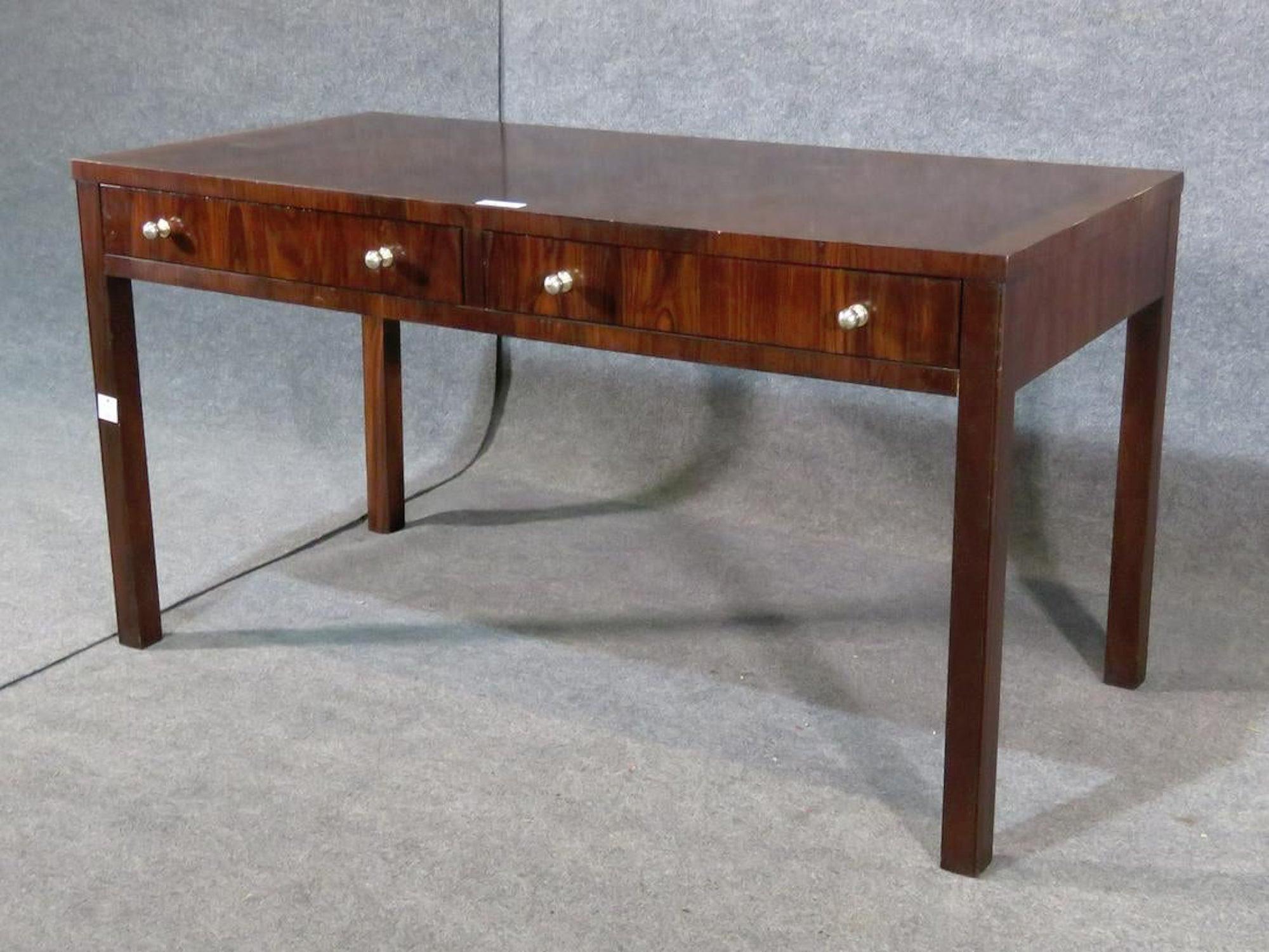Midcentury desk in rosewood grain with two drawers.
(Please confirm item location - NY or NJ - with dealer).
  