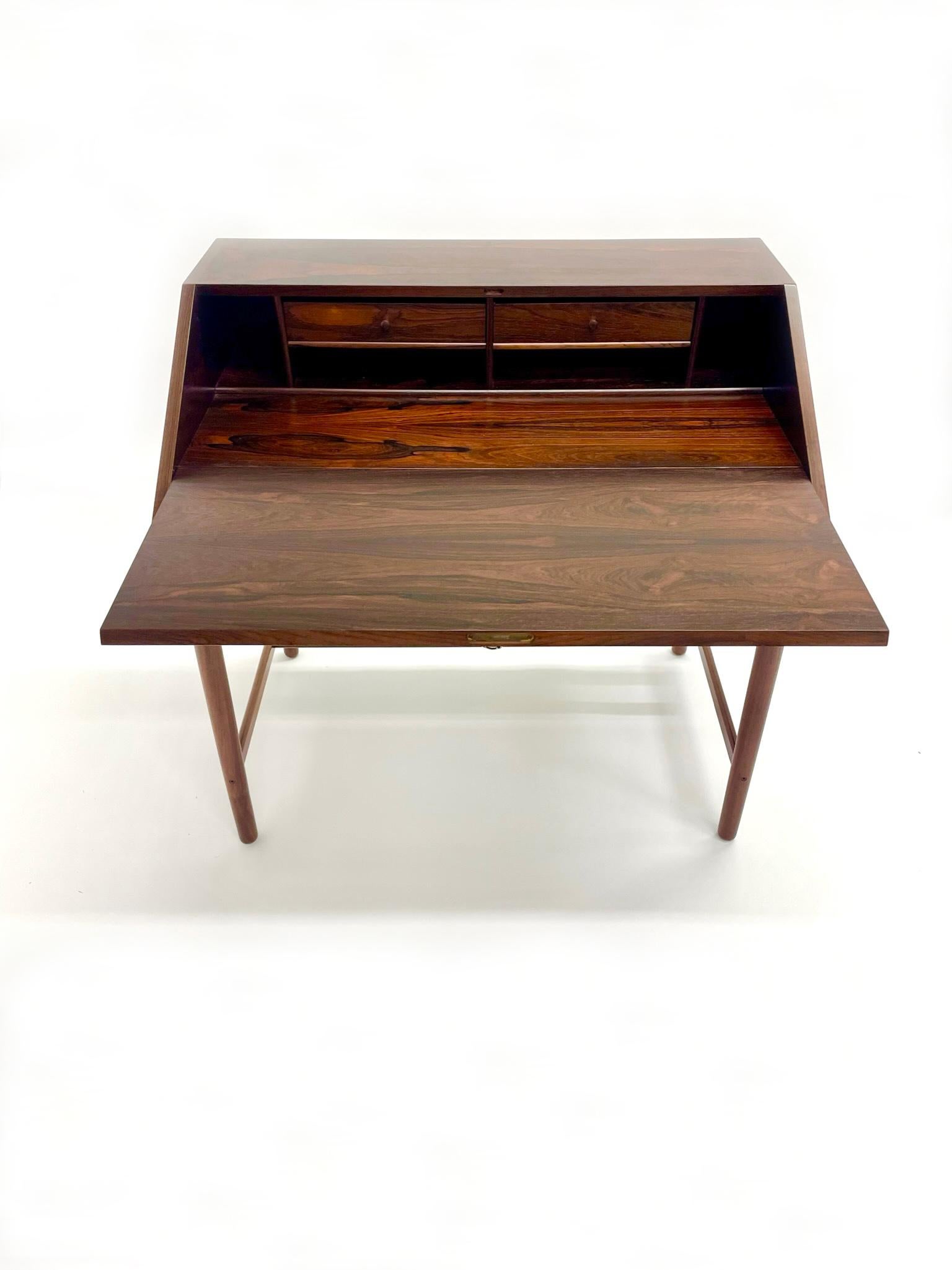 Rare hand-crafted rosewood desk designed by Torbjorn Afdal for Bruksbo. The drawers made with very fine detailed zipper joinery. With original key and working lock mechanism. Original key and lock in working condition.

Has been completely restored.
