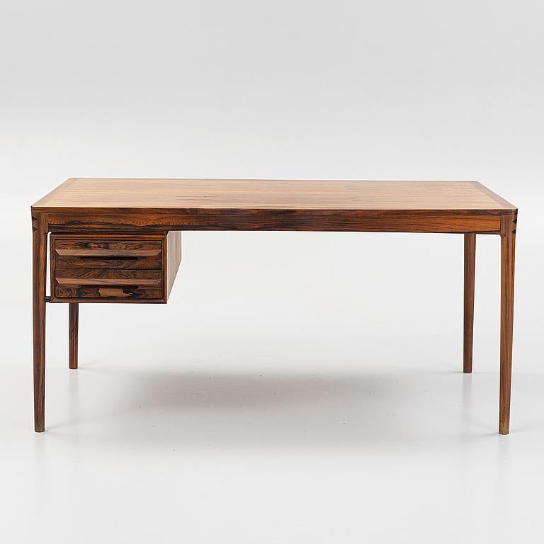 A unique and typical design by Torbjorn Afdal, considered one of the most important Scandinavian designers of the 50s and 60s. With a clean and pure form this desk has two drawers with beautifully sculpted handles and very pretty assemblies between