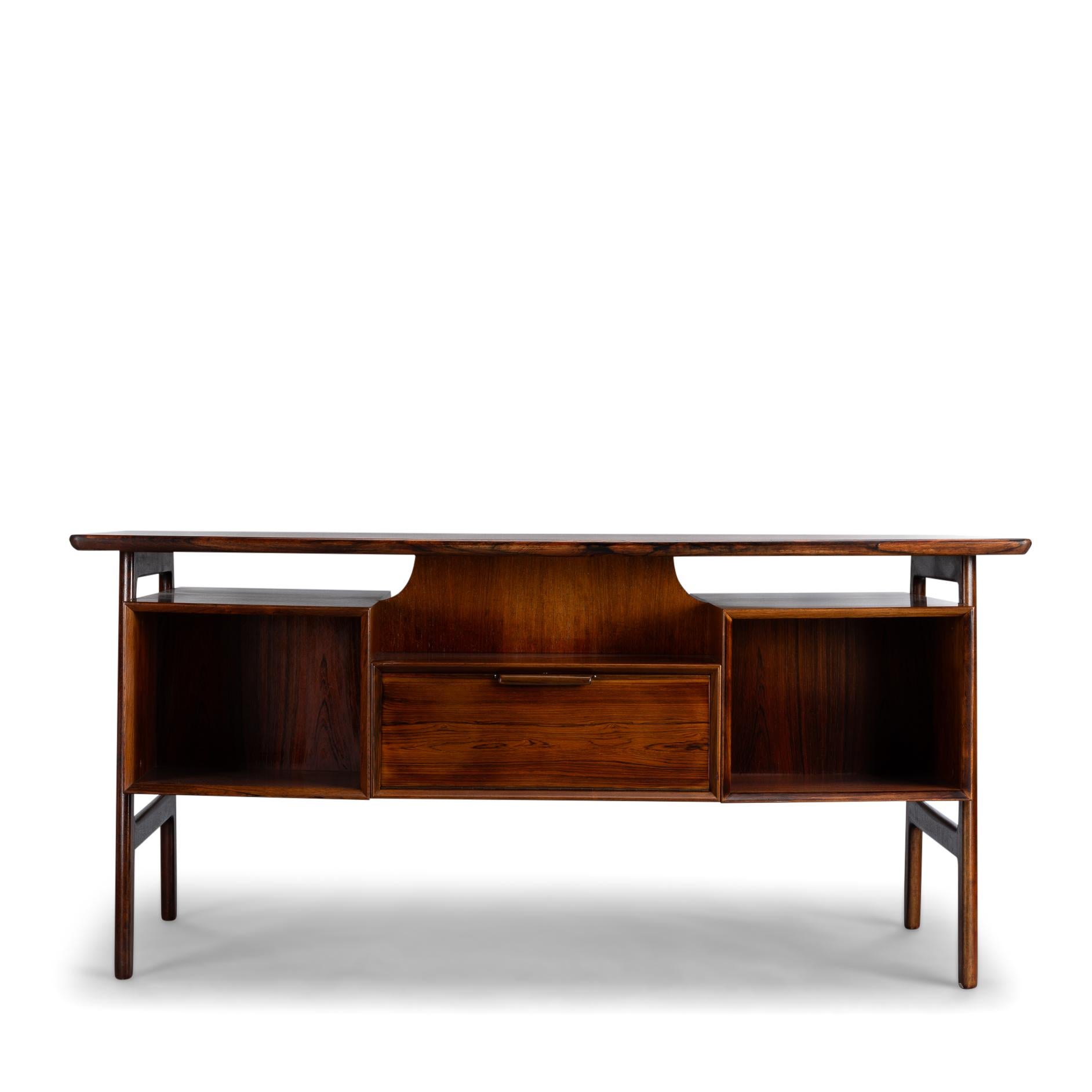 Design desk
Splendid midcentury Danish modern ''model 75'' executive desk designed by Gunni Omann for Omann Jun Møbelfabrik in the 1950s. This refinished vintage desk features six drawers with elegant sculpted wood pulls. Additional storage space is
