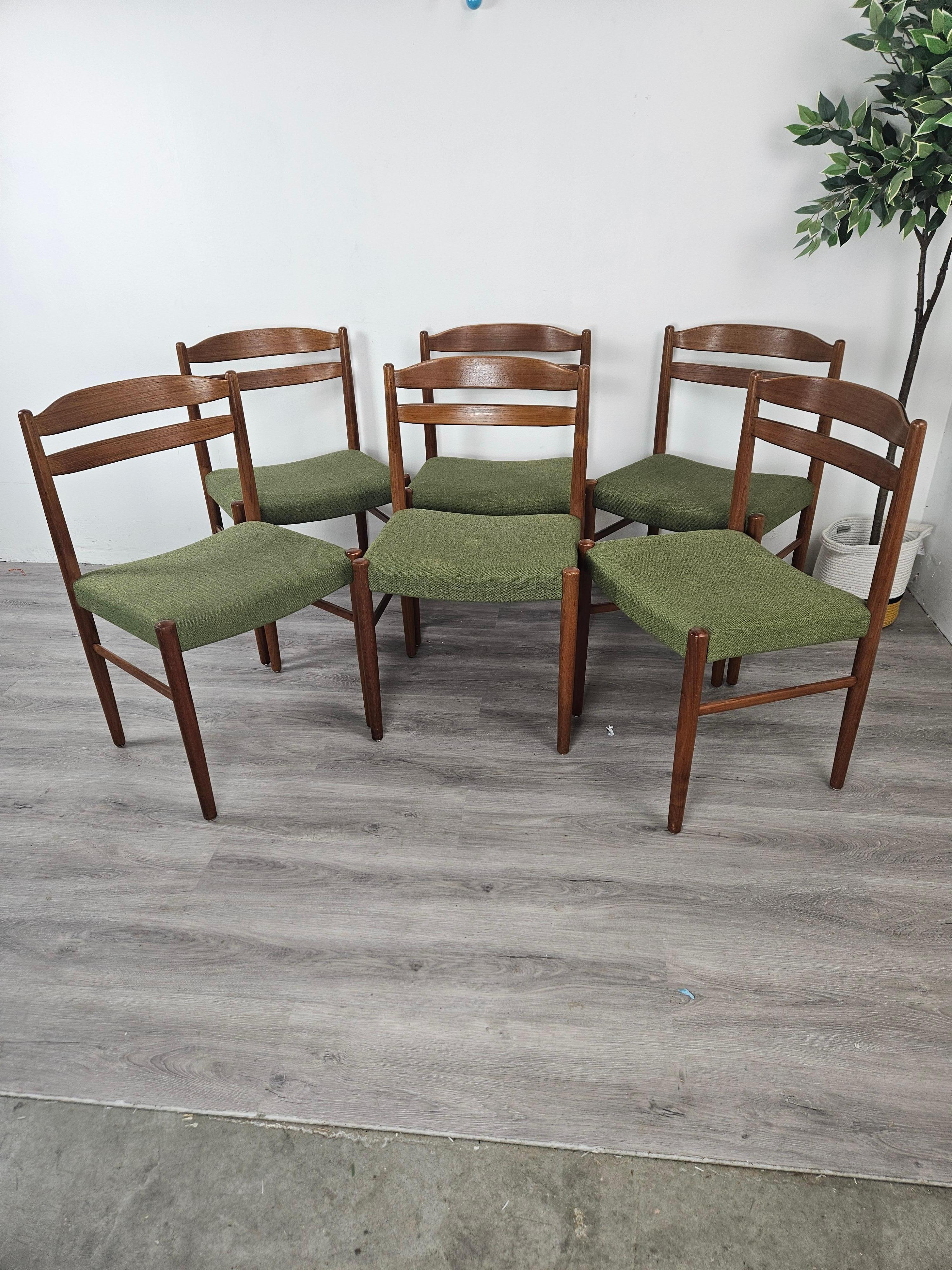 This set of 6 Scandinavian Modern dining chairs were purchased from a vintage seller in Denmark and imported the the US. The elegant curved design of the back and turned legs are iconic of Danish and Swedish design of the 50s and 60s. Designed by