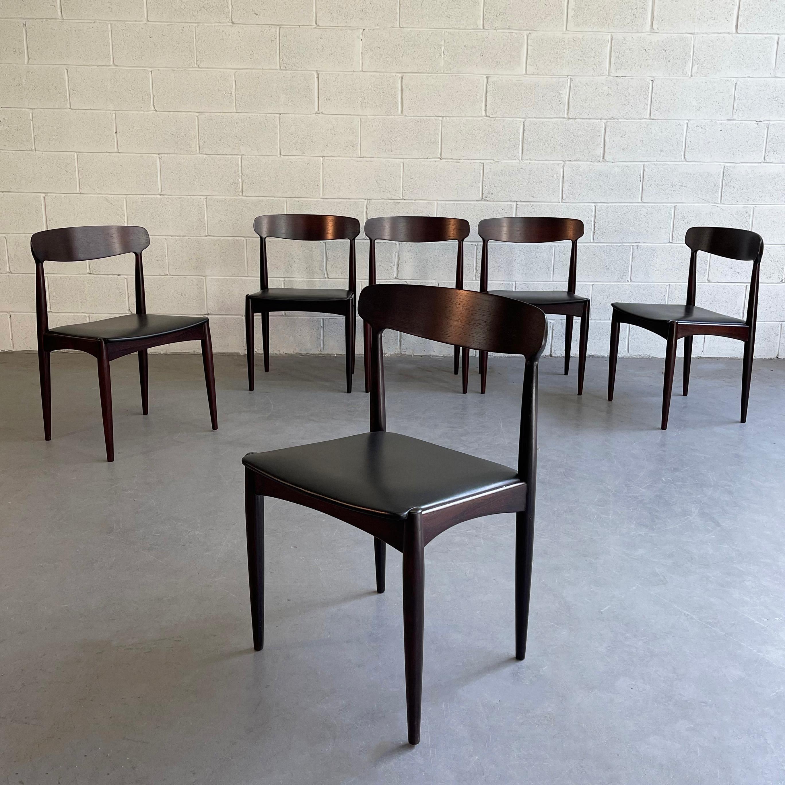 Set of 6, Danish modern dining chairs by Johannes Andersen for Uldum Møbelfabrik feature rosewood frames with black leather seats.