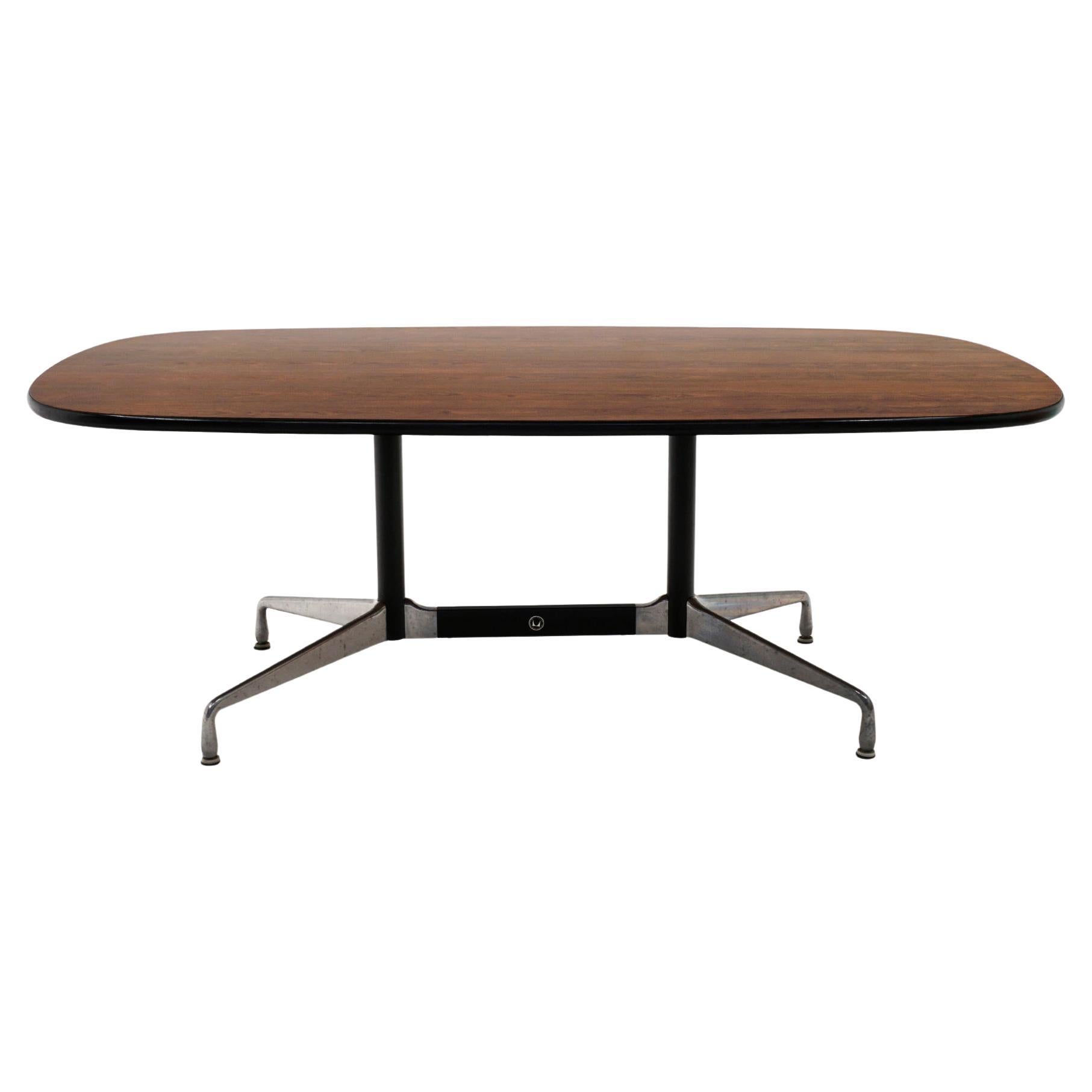 Rare Brazilian rosewood version of the Charles and Ray Eames designed aluminum group dining / conference table. The top is wood and not a laminate. Very good condition with light signs of wear to the top. Aluminum base shows some areas of