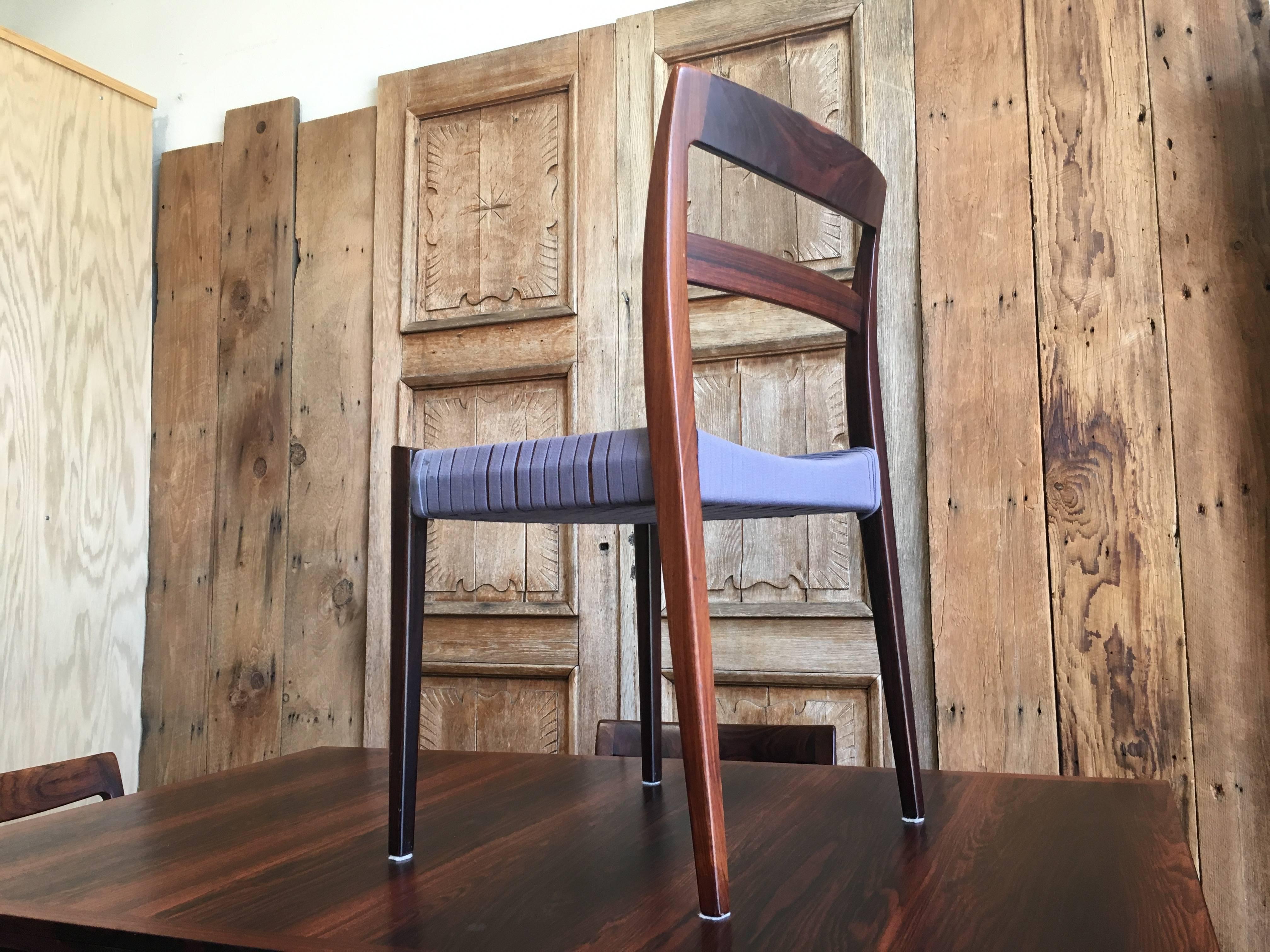 Rosewood draw leaf table with four chairs with original woven web seats
The table is 55