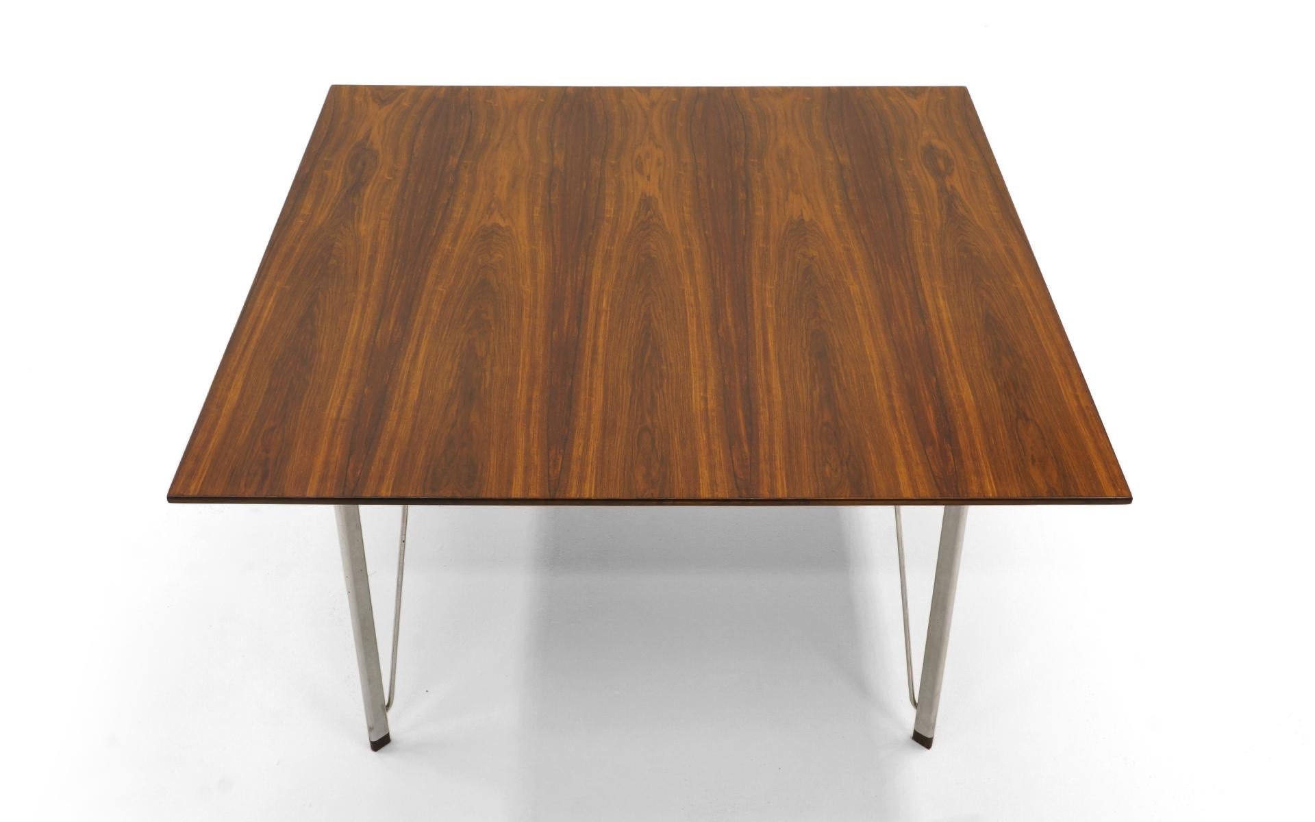 Beautiful Brazilian rosewood dining table designed by Arne Jacobsen and manufactured by Fritz Hansen, Denmark, 1960s. Rosewood top and feet with satin chromed steel legs. The top is in very good to excellent condition with only very light scratches