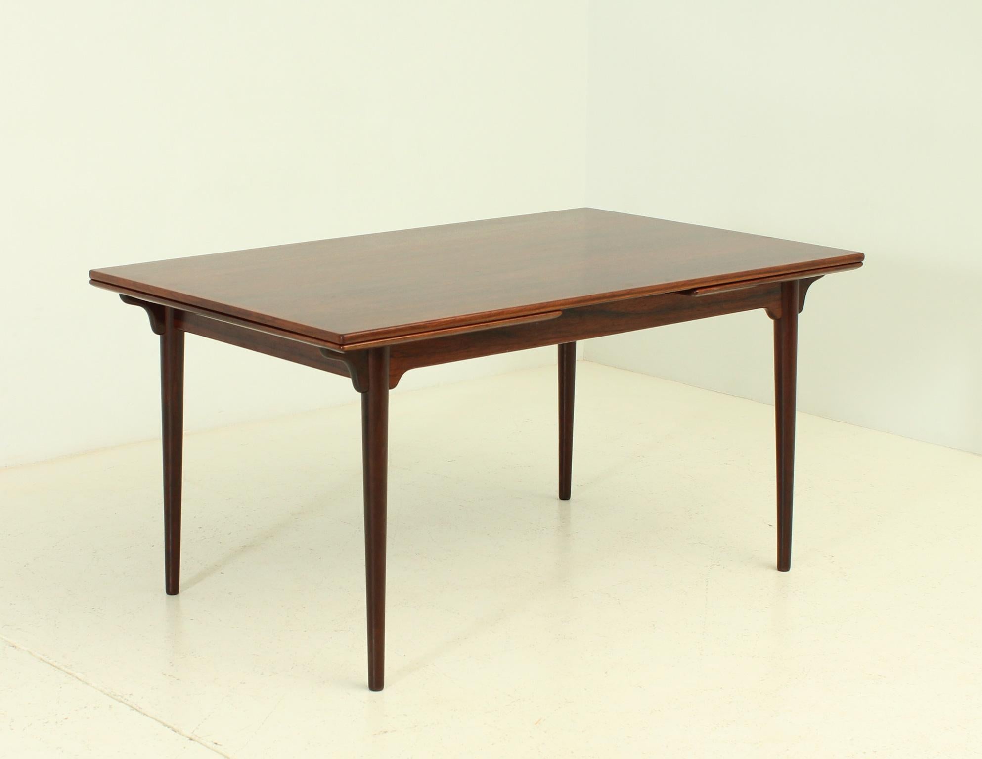 Dining table model number 54 designed by Gunni Omann in 1960's for Omann Jun, Denmark. Hardwood with two extensions of 54 cm. in each side.

Dimensions: 145/253 W. x 90 D. x 73 H. cm.
 