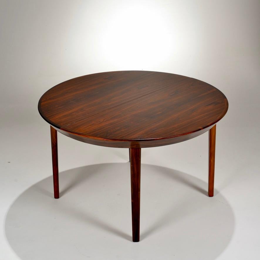 This is a wonderful Danish rosewood dining table by Ole Hald for Gudme Mobelfabrik. Professionally refinished to original condition.