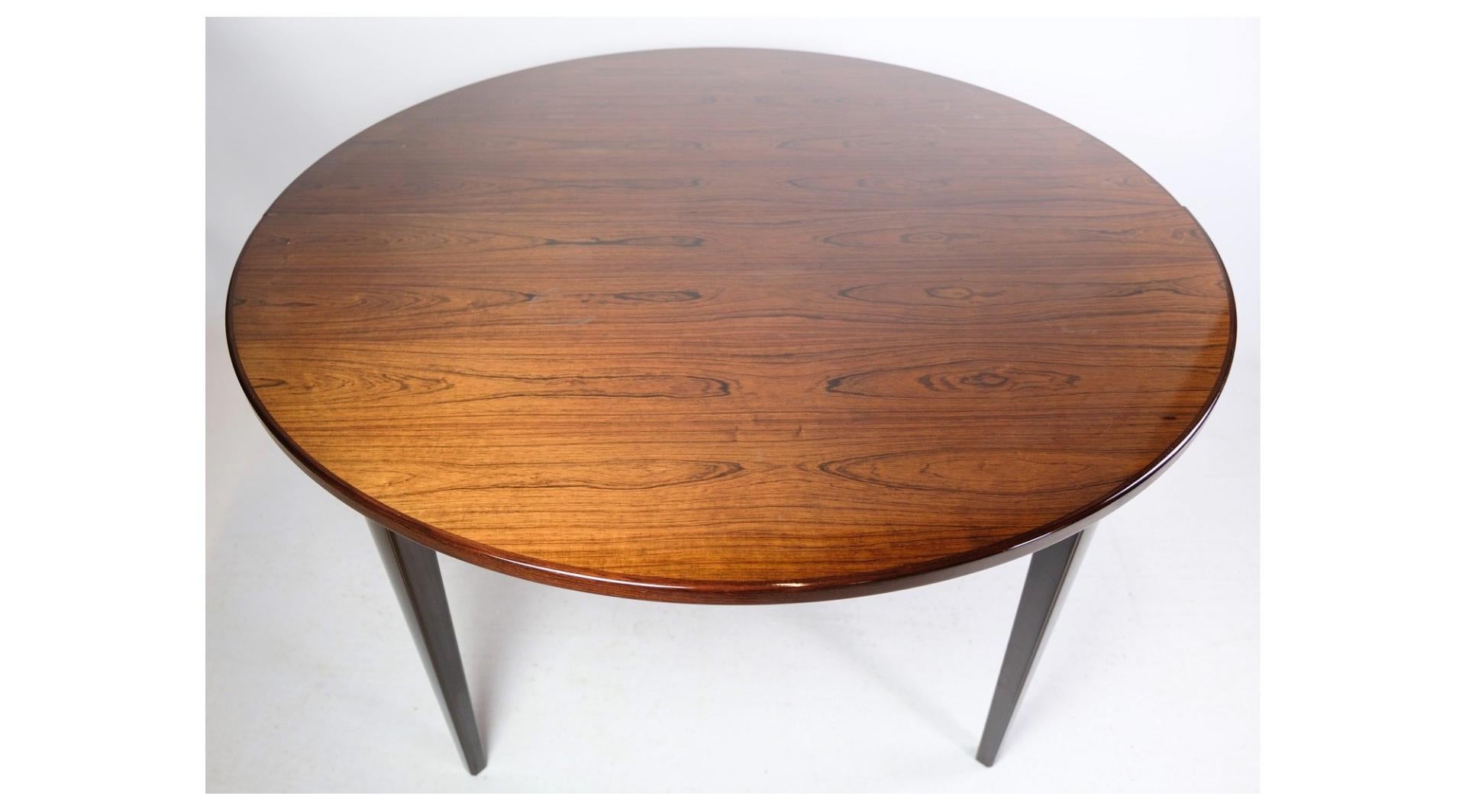 The dining table in rosewood, designed by Omann Jun. A/S, model no. 55 and from around the 1960s, represents a fine example of mid-20th century Danish furniture design.

Oman Jun. A/S was known for their quality furniture, and the model no. 55