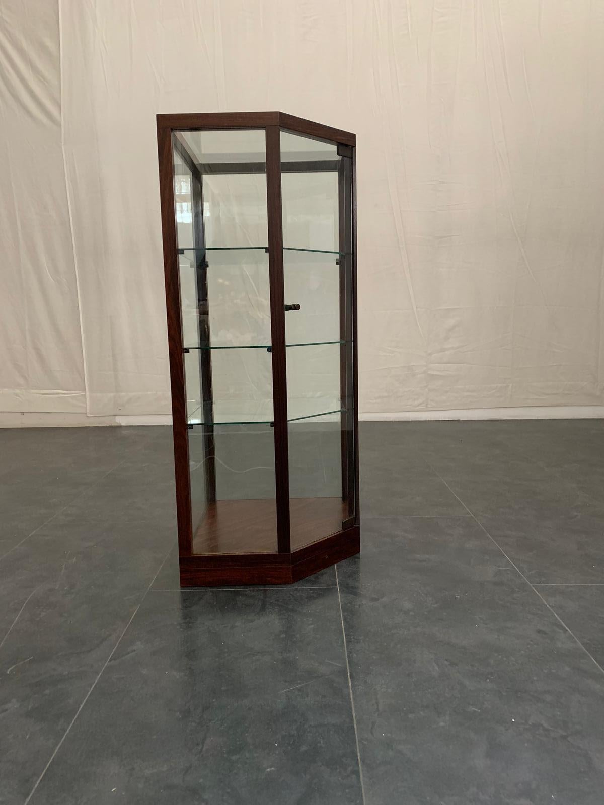 Display cabinet with bevelled corner on the front structure and base in solid rosewood, contains 3 shelves adjustable in height, Italy '60s.
Packaging with bubble wrap and cardboard boxes is included. If the wooden packaging is needed (crates or