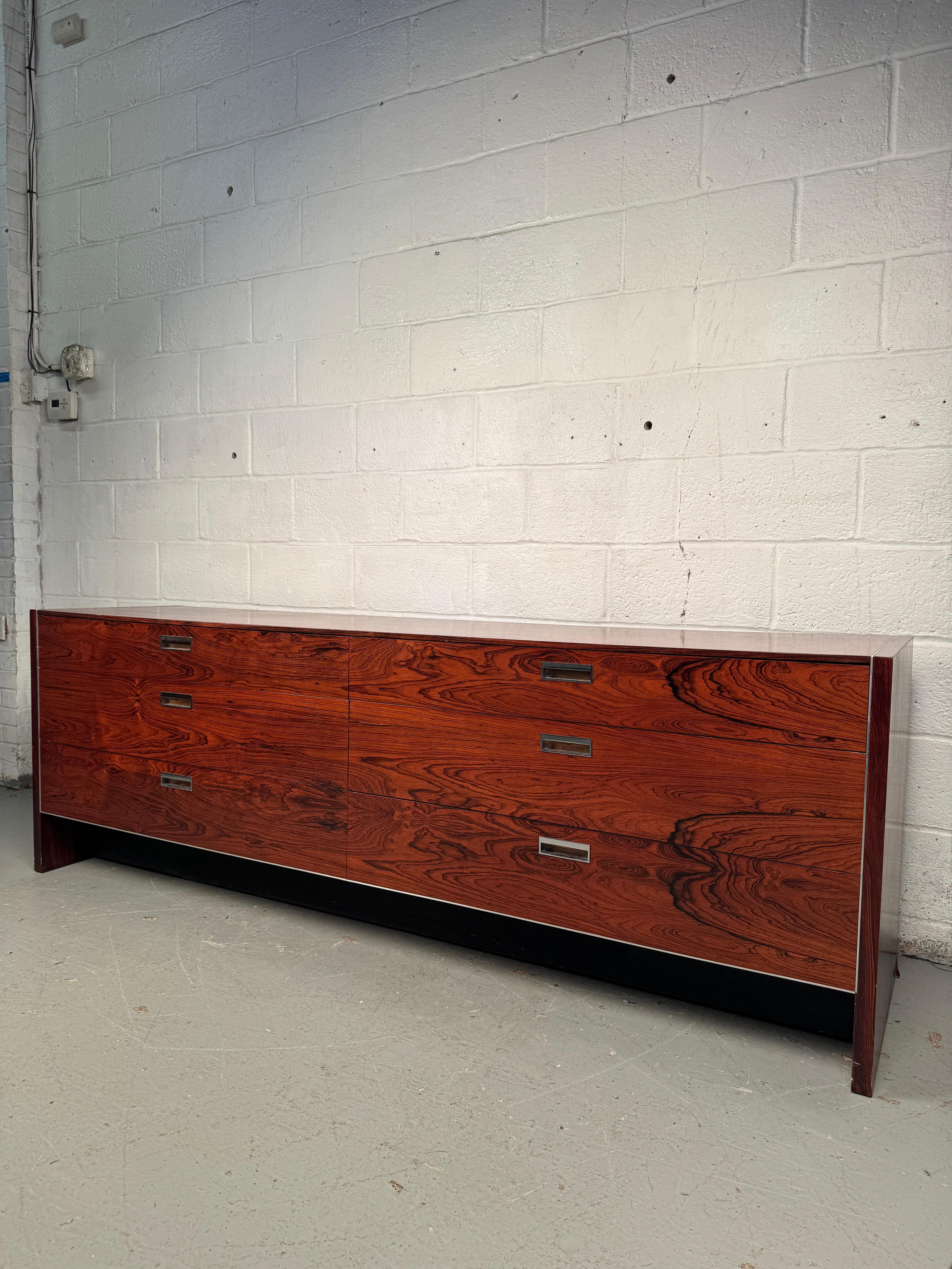 Elegant rosewood dresser designed by Robert Baron for Glenn of California, crafted in richly toned rosewood. Clean modernist lines and warm natural grain. This dresser offers refined style and practical storage. A sophisticated example of California