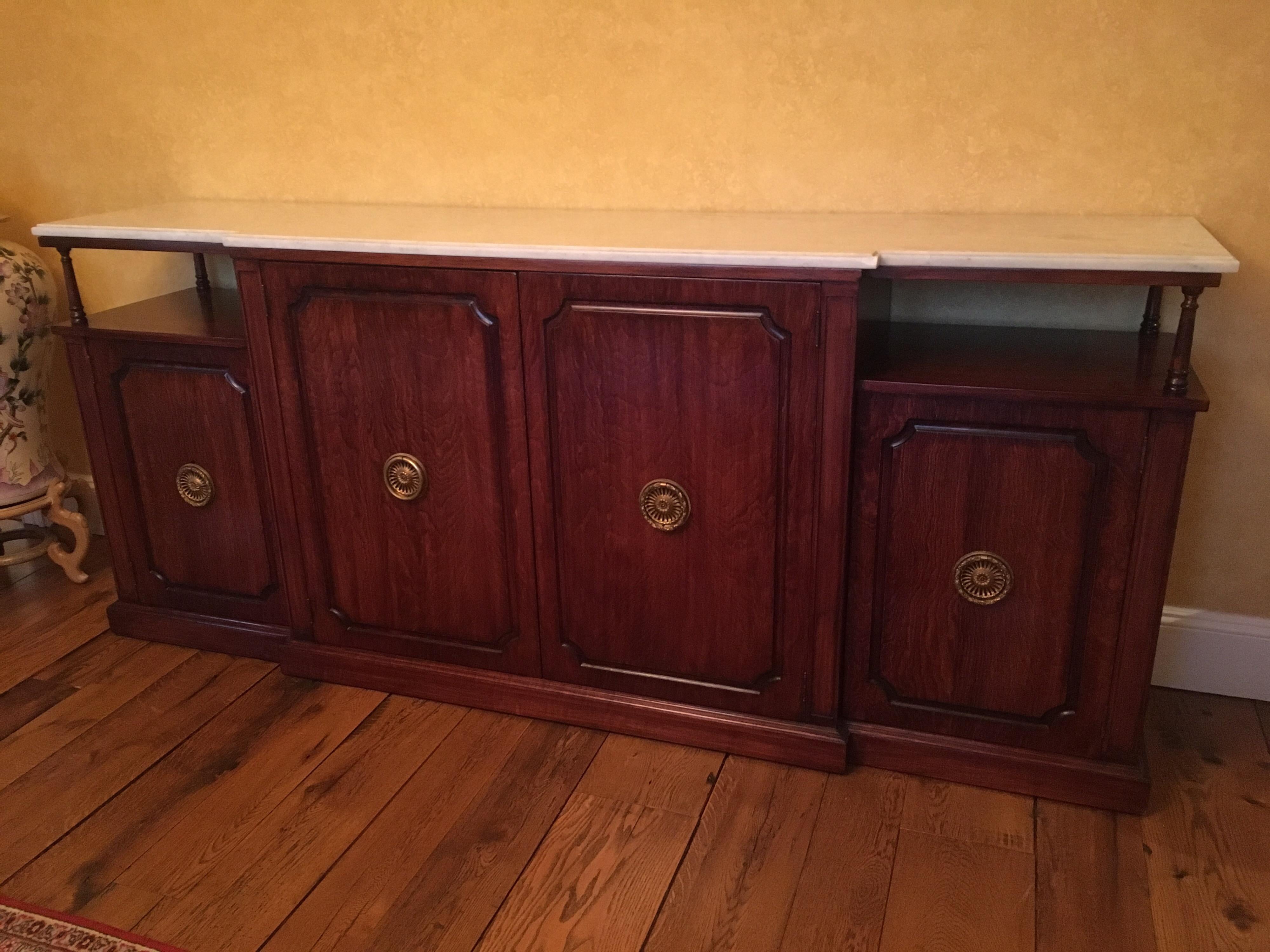 Rosewood Empire style credenza sideboard with marble top, circa 1950s. Original hardware. A chip to the marble on the right facing edge of the top is shown in photo.

Shelf above two smaller doors: 8