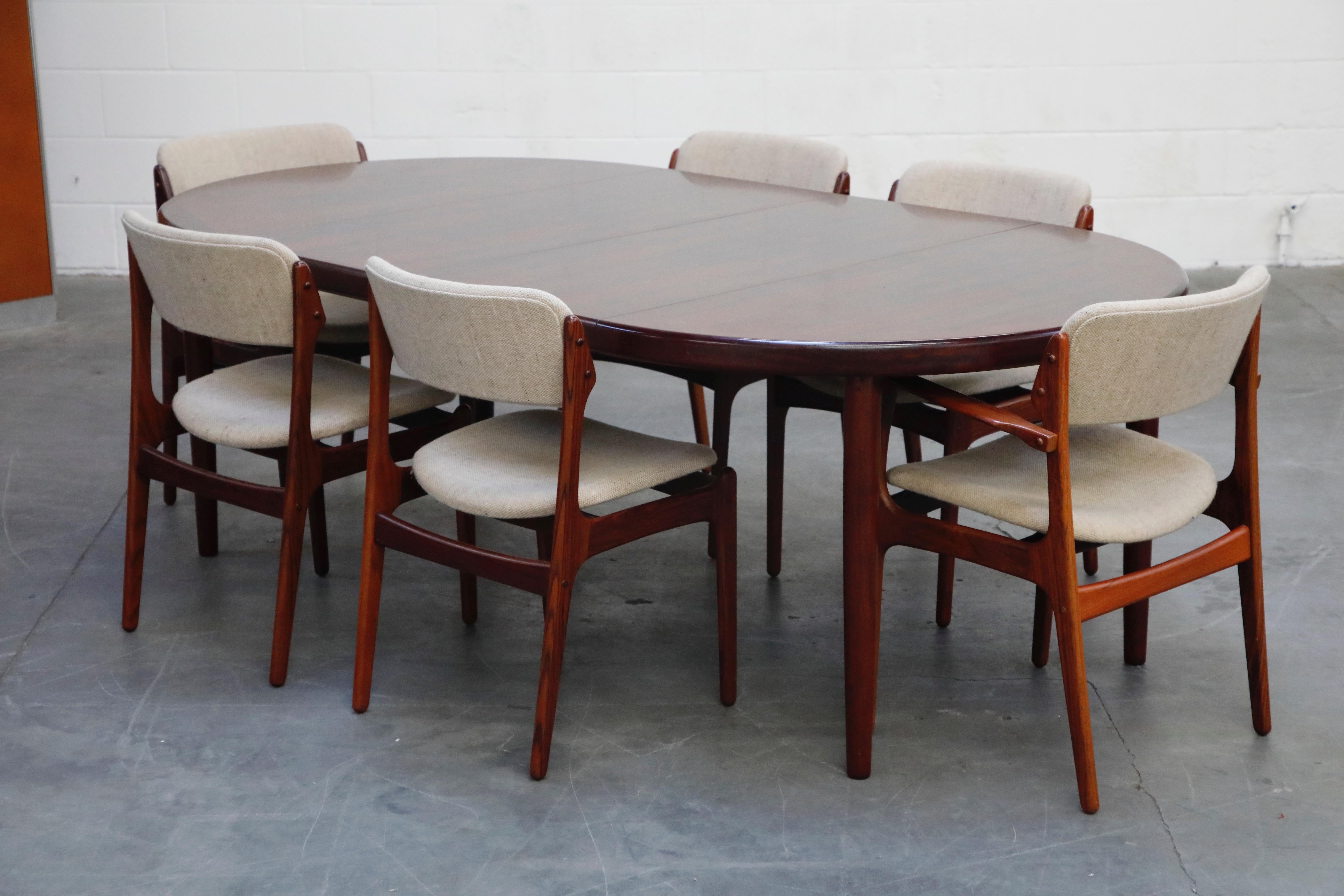 The gorgeous rosewood on this dining set by Erik Buch for Oddense Maskinsnedkeri is deep grain and vivid with beautiful color and condition. This set comes with an expandable dining table that comes with two leaves, and six Model #OD-49 dining