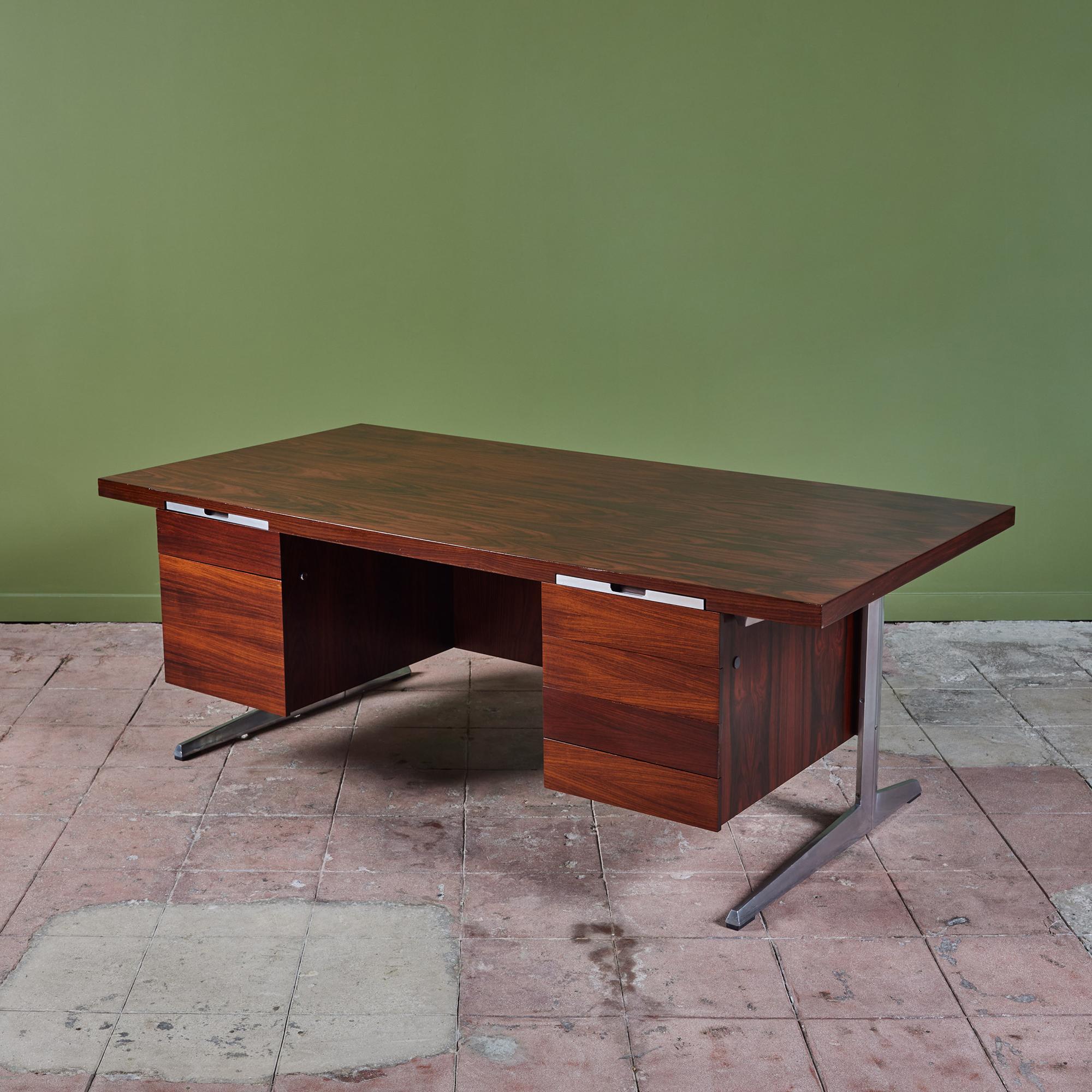 A stunning rosewood executive desk by Marius Byrialsen for Nipu, c.1960s, Denmark. The desk features an aluminum frame with a rosewood desk top, six drawers and two narrow pencil drawers, flanking either side of the seating area. The left-hand side