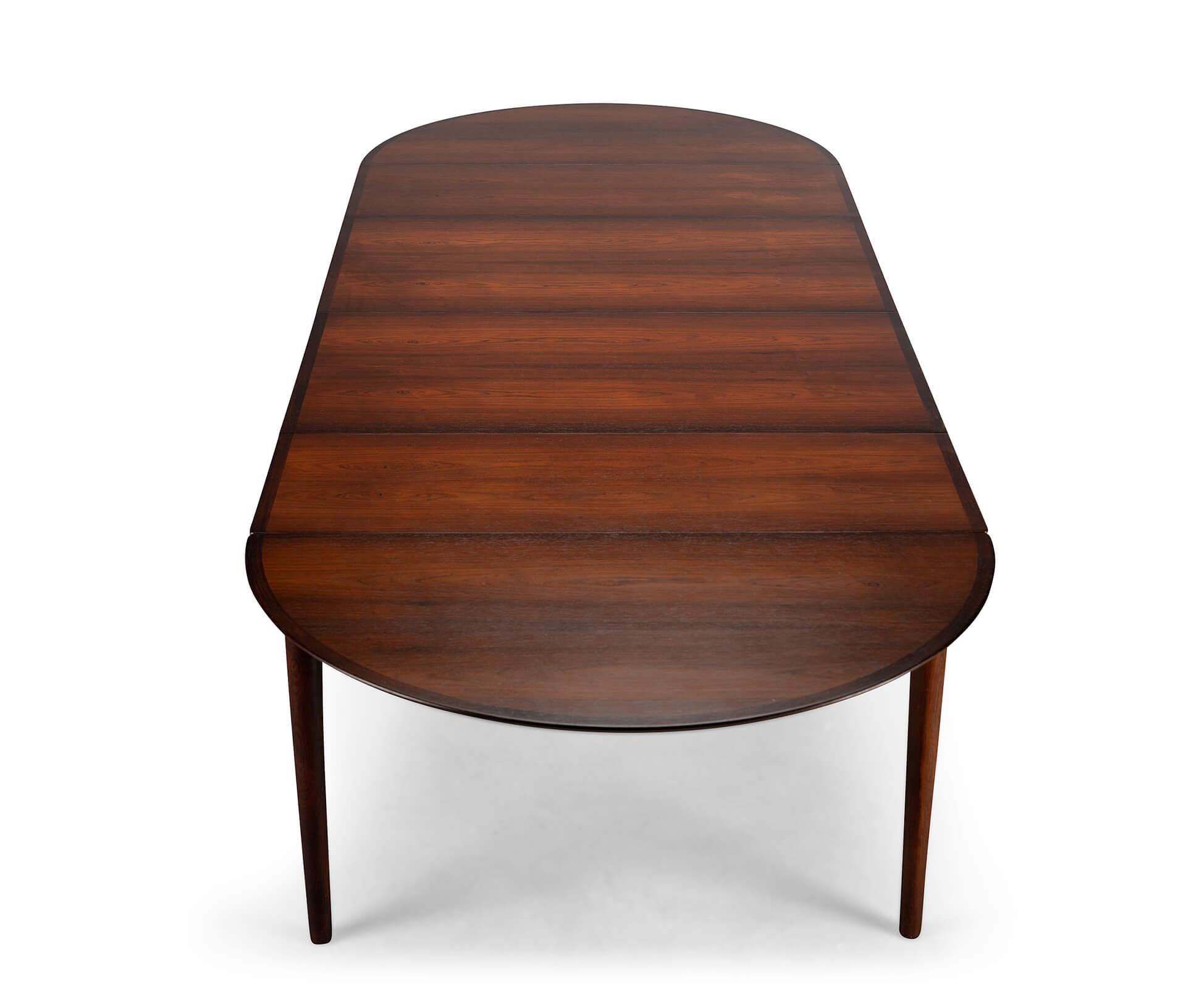 Table Model 227 by Arne Vodder This gorgeous classic Danish Model 227 dining table by Arne Vodder for Sibast was made in the 1960s. This particular adjustable dining table is made off rosewood. The table convinces with it's very high quality