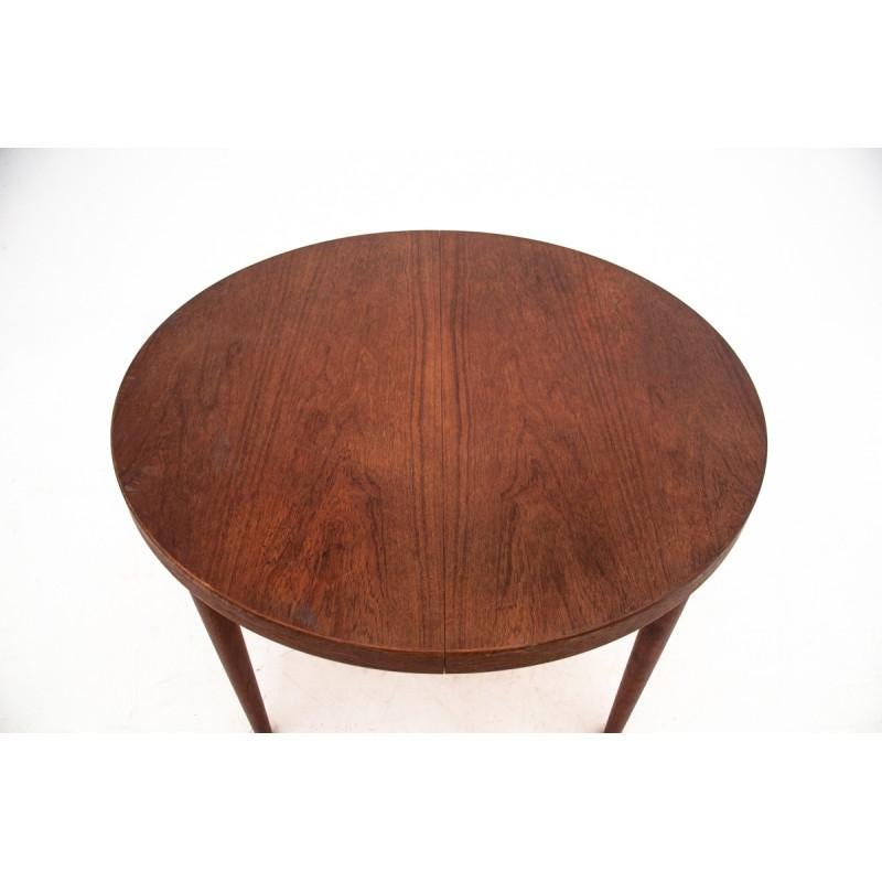 Rosewood round table comes from Denmark in the 1960s. In excellent condition, after the wood renovation process. It has one additional insert that allow it to unfold up to 170 cm.