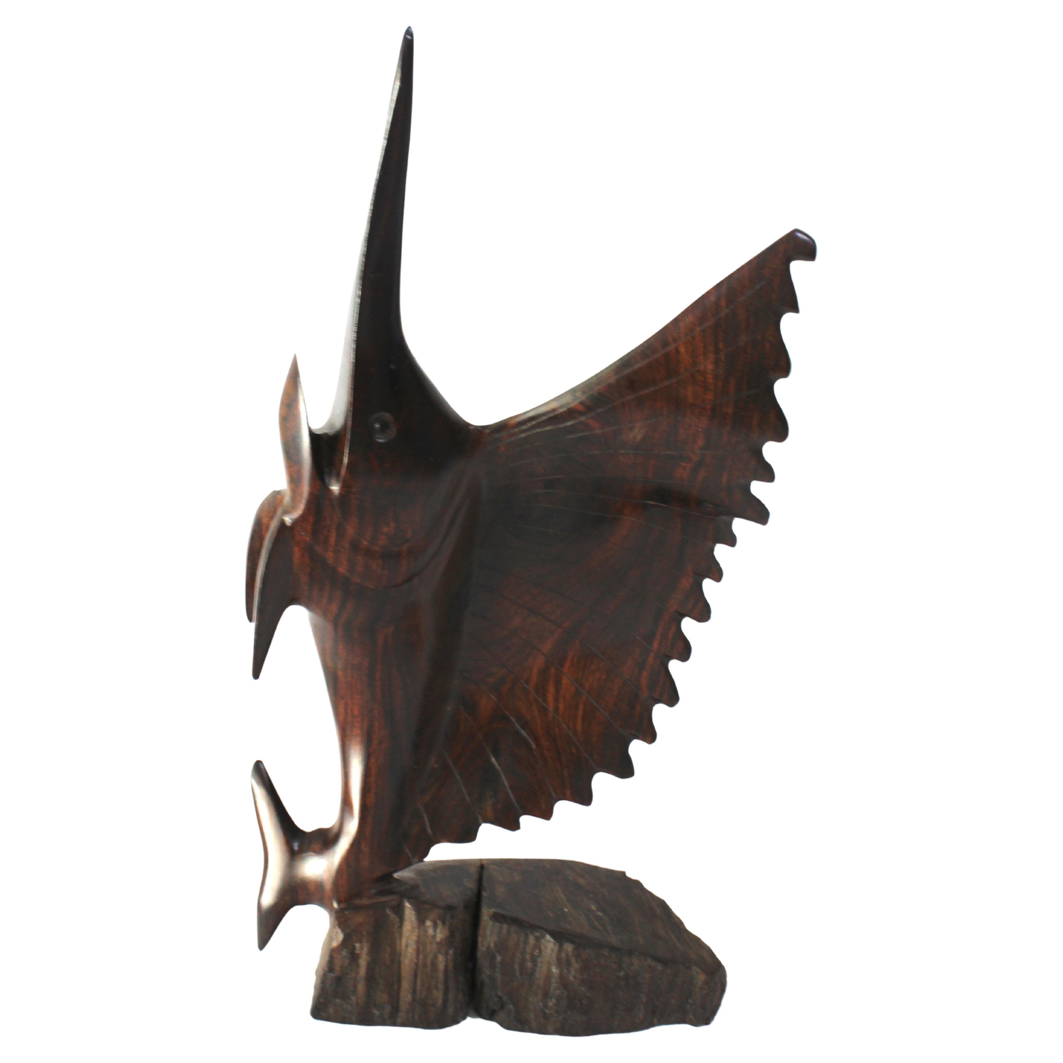 This stylish rosewood figure of a sailfish was created in Bali and it will make a subtle statement with its form and use of materials.