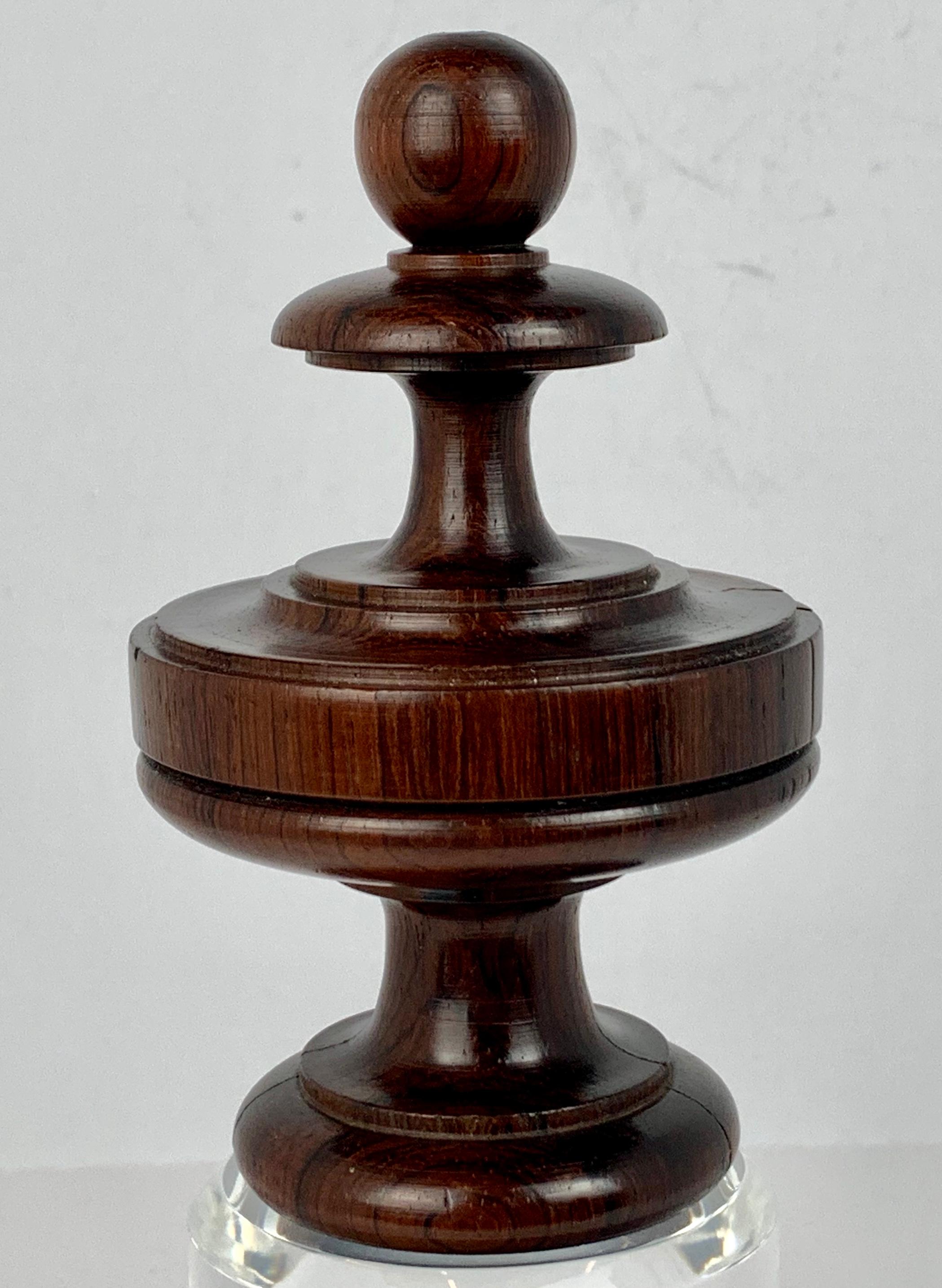 Rosewood turned finial originally crafted for a fine piece of 19th century furniture. We have had it hand polished and placed on a custom beveled Lucite pedestal. 
Polished by hand in our workshop.
The overall height is 8.25