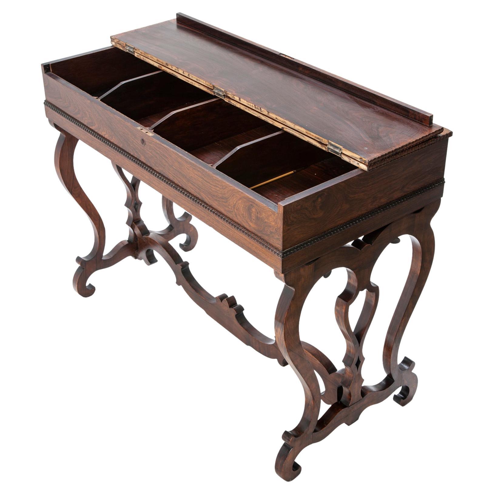 Antique European rosewood writing table. Hidden beneath the flip top, a desk in excellent condition. Stunning stretchers & base. This piece is in remarkable pristine condition., there are 4 roomy compartments under the lid.

