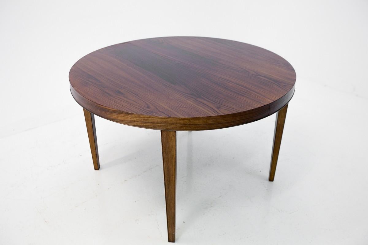 Rosewood round table comes from Denmark in the 1960s. In excellent condition, after the wood renovation process. It has one additional insert that allow it to unfold up to 167 cm.