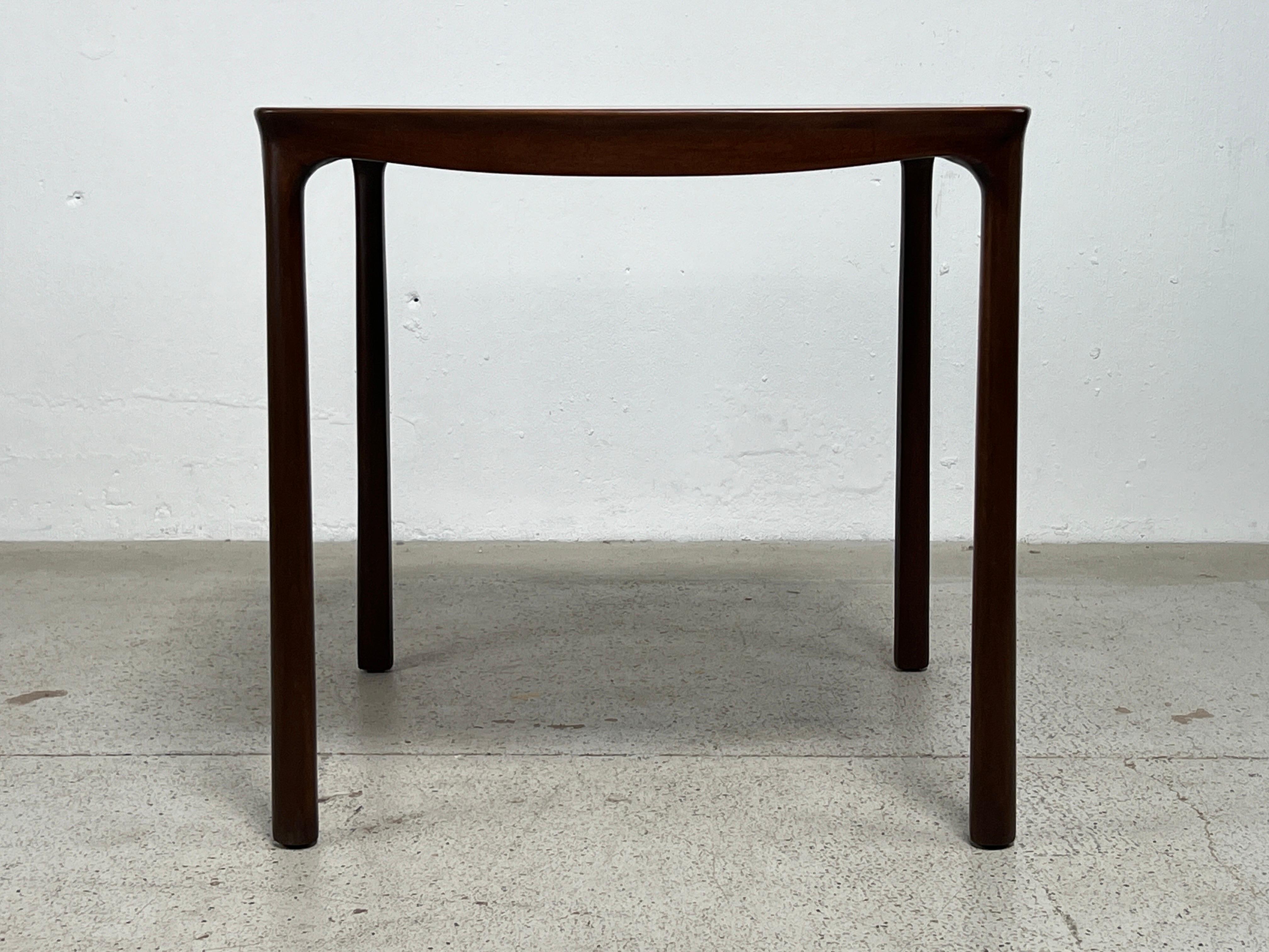 A rosewood and mahogany game table designed by Edward Wormley for Dunbar. 