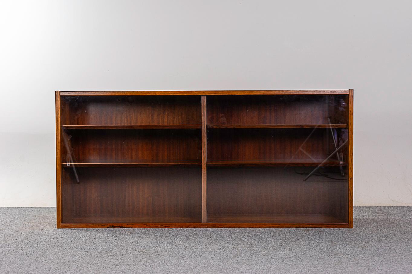 Rosewood & glass cabinet by Hundevad, circa 1960's. Lovely book-matched veneer, adjustable beveled edge shelving and glass doors keep your treasures dust free. Hundevad makers' mark intact.

Unrestored item with option to purchase in restored