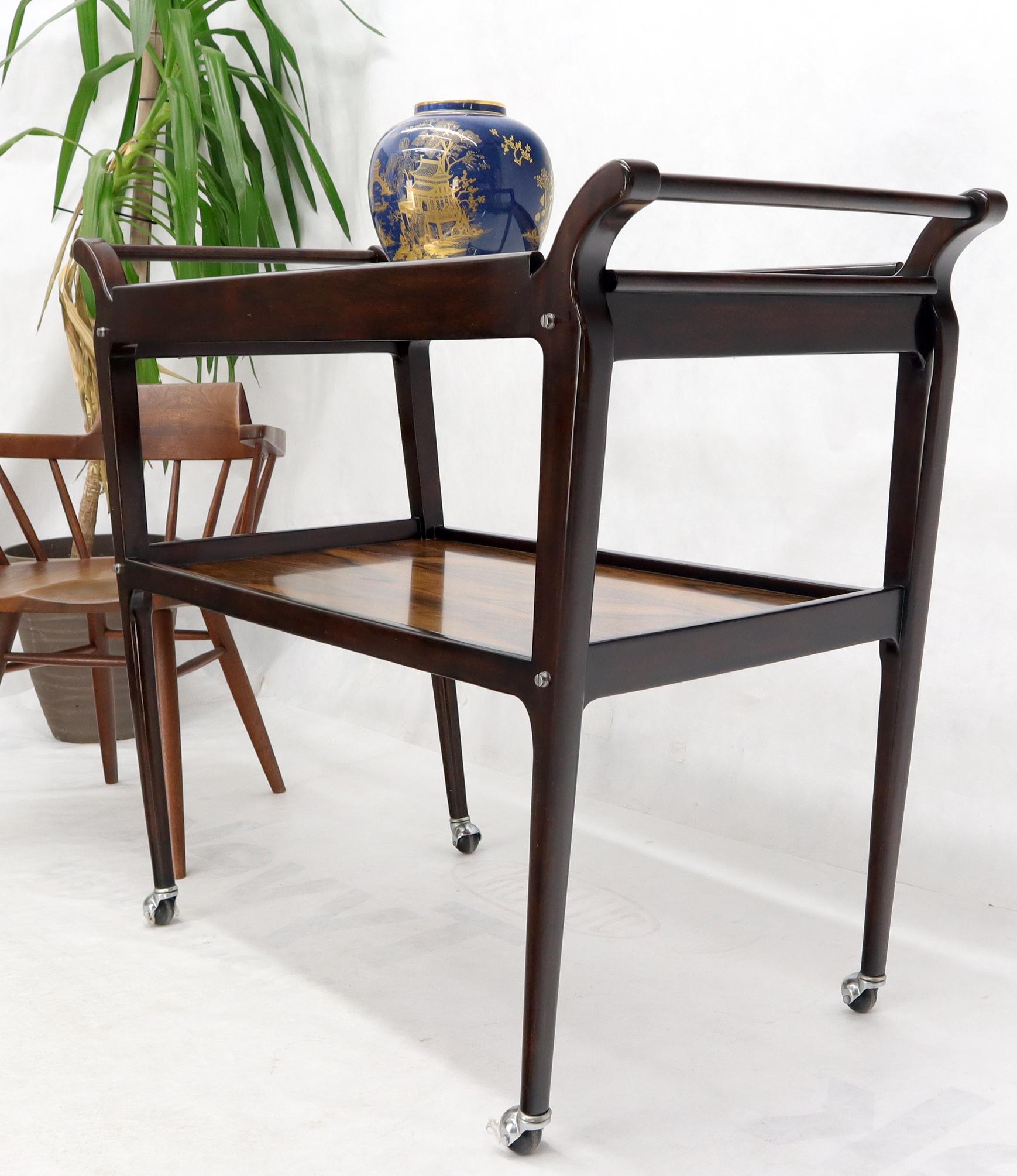 Mid-Century Modern rosewood two tier serving cart table on wheels.