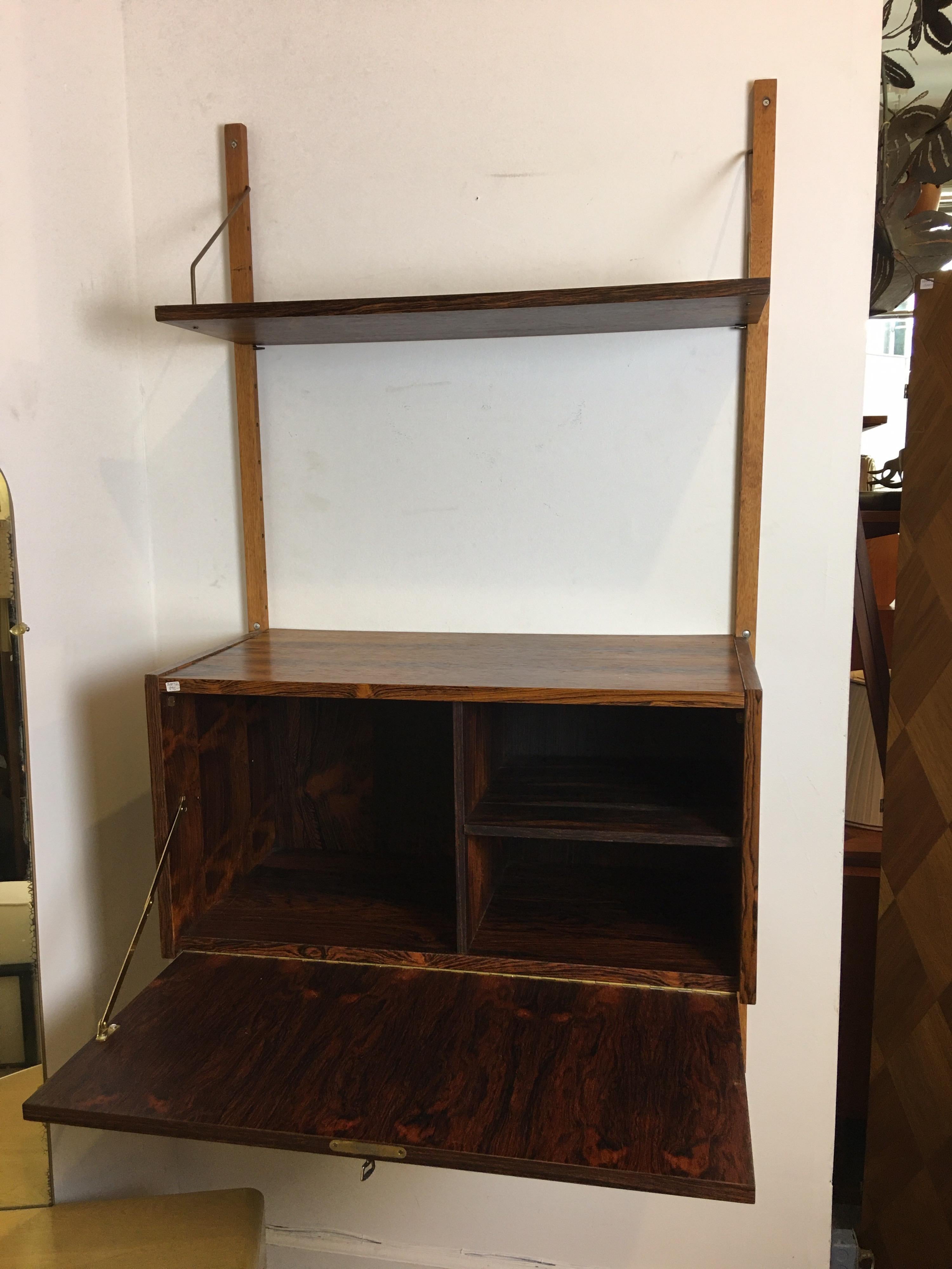 Very useful hanging rosewood wall unit, one bay wide. Adjustable cabinet and shelf. Perfect to use as a bar or entry piece! Rosewood is very clean, unit has 1 key, 2 wall brackets, 1 drop-front cabinet and 1 shelf. Cabinet is 15.5 deep, 31.5 wide
