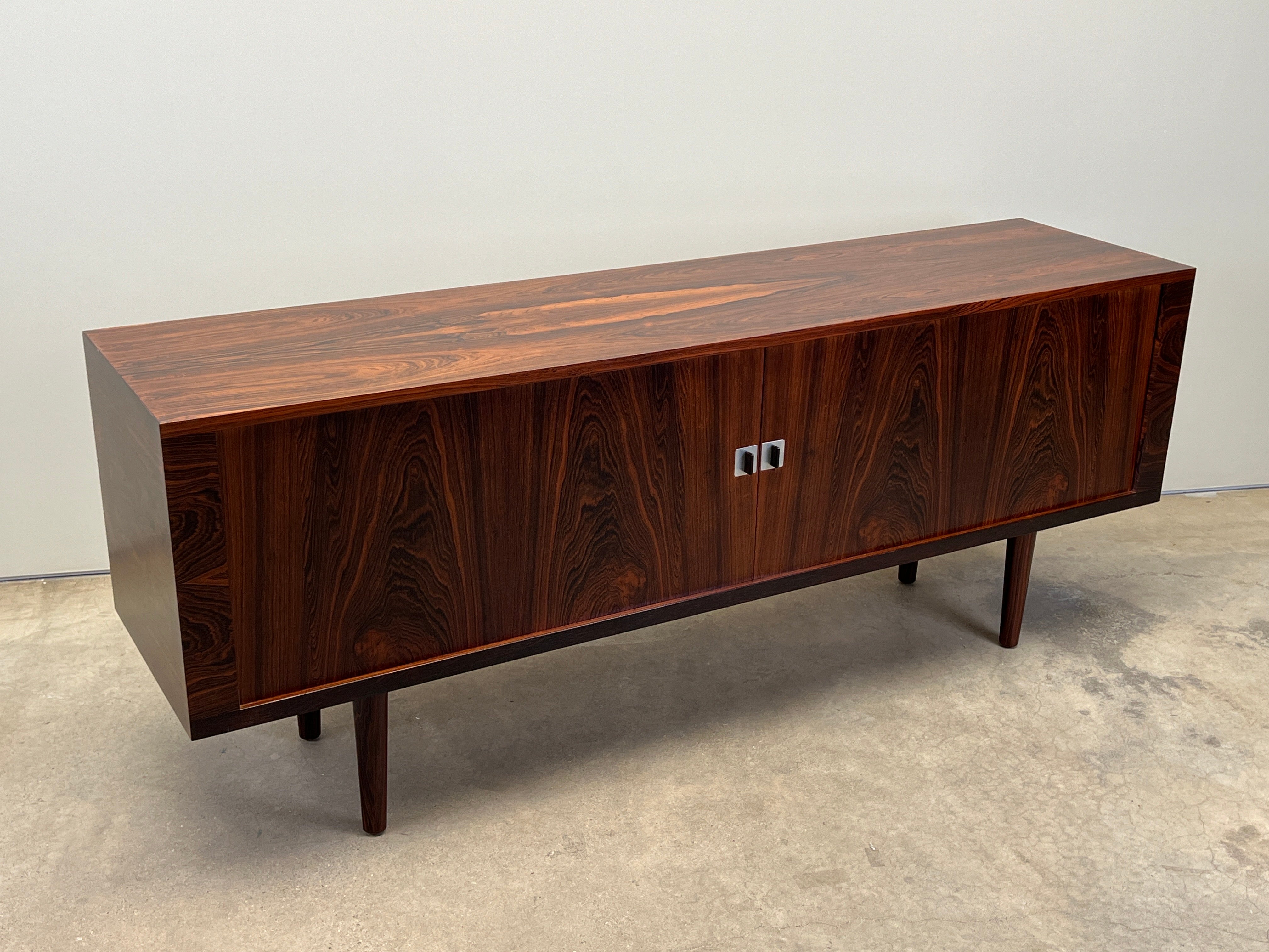 A vibrantly grained rosewood credenza with tambour doors and white oak interior. Designed by Hans Wegner for RY Mobler. Beautifully restored. 