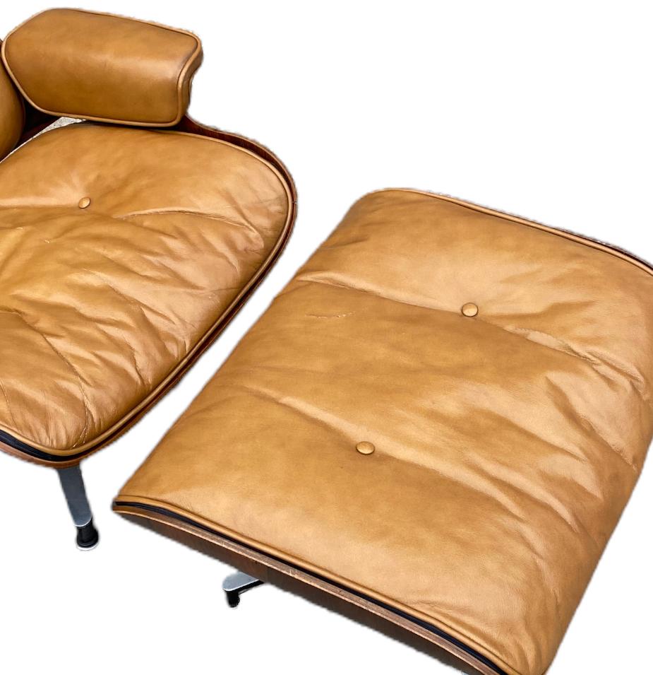 Iconic vintage Herman Miller Eames lounge chair and ottoman. Original butterscotch leather cushions with foam/down filling. Spectacular rosewood color and grains. Signed and guaranteed authentic. Shock mounts replaced in seat panel. Chair swivels