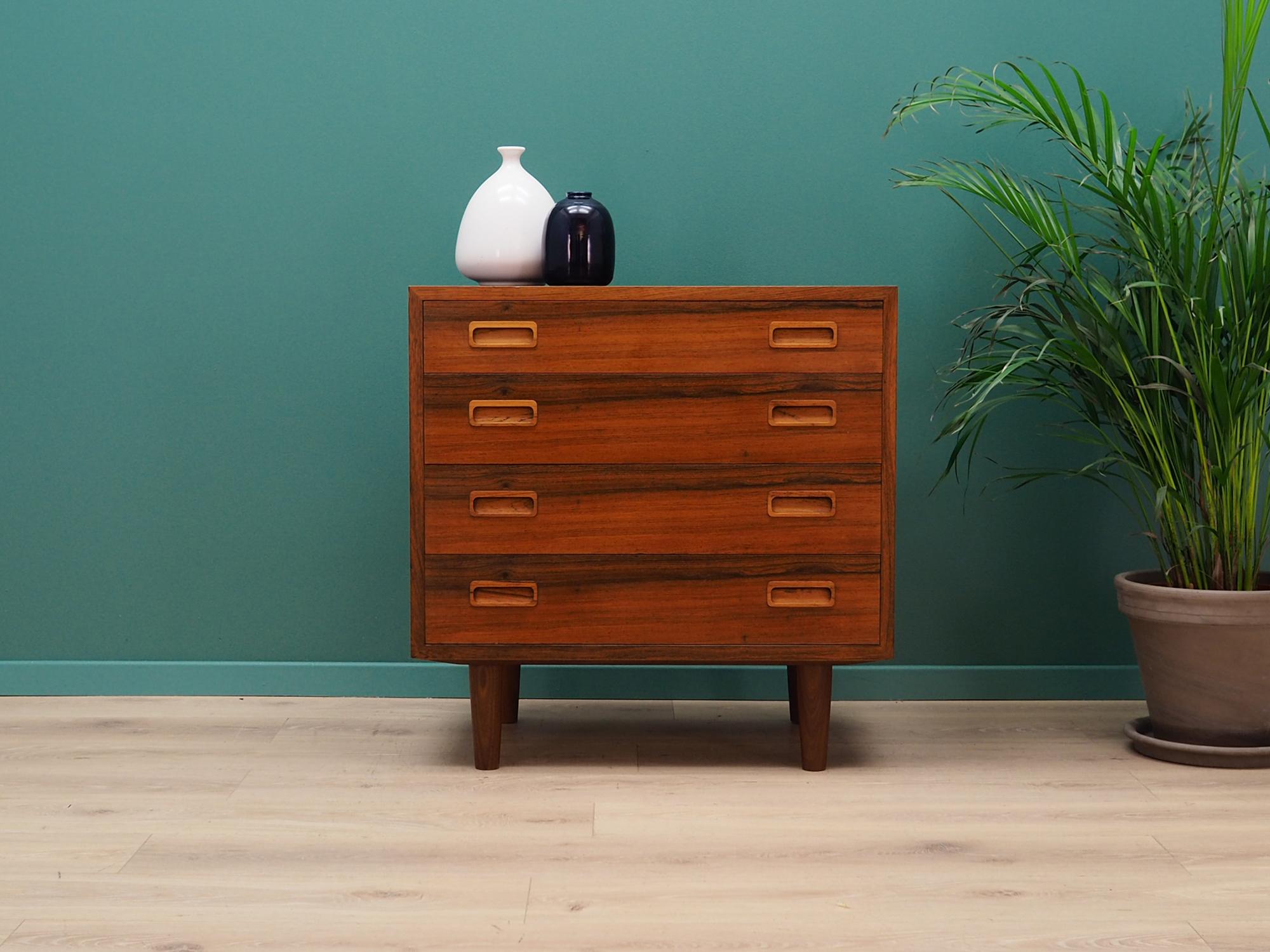 Fantastic chest of drawers from the 1960s-1970s. Scandinavian design, Minimalist form. Manufactured by Hundevad & Co. The furniture is finished with rosewood veneer. The chest has four packed drawers. Preserved in good condition (minor bruises and
