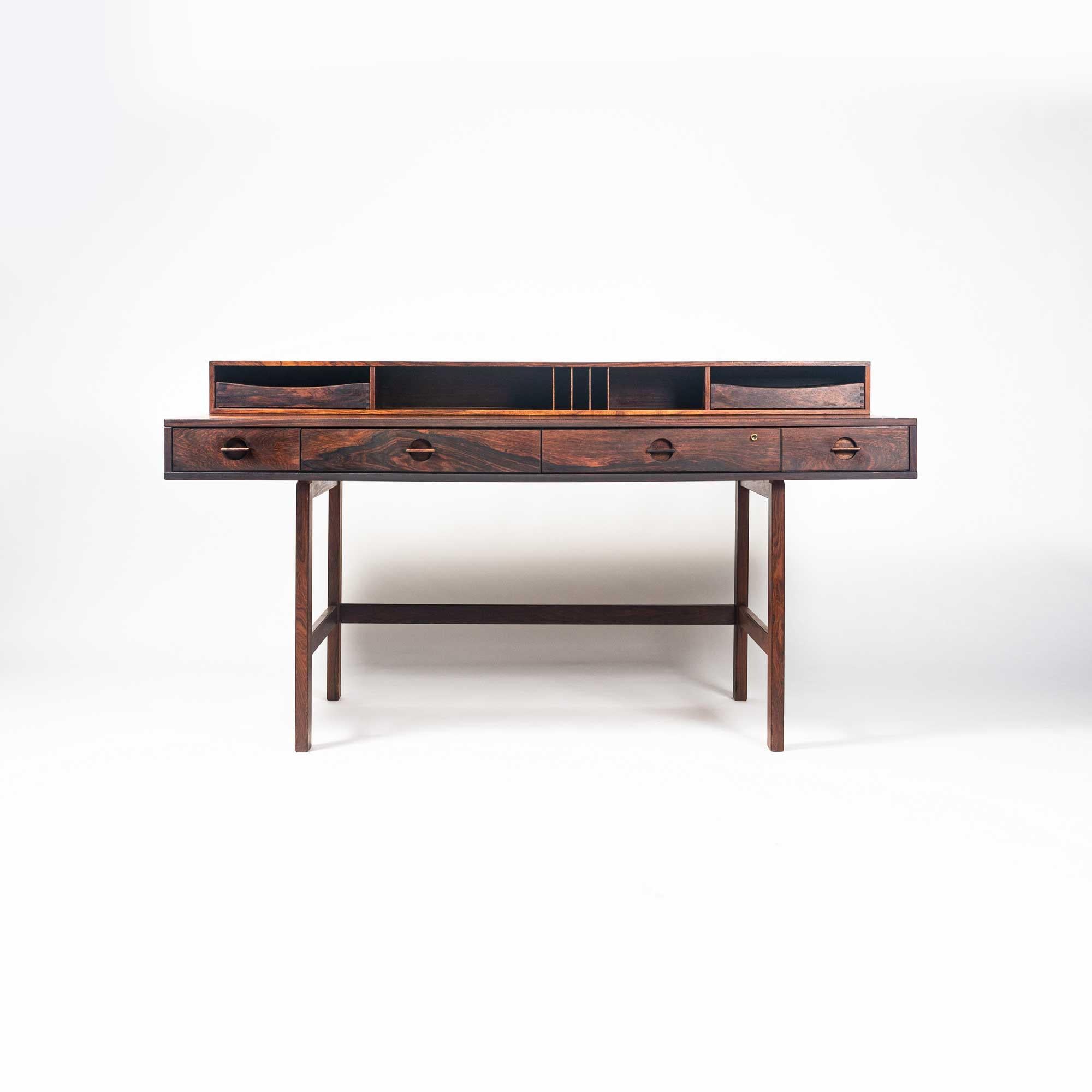 Extremely rare Flip top partner's desk by Peter Lovig Nielsen in rosewood with brass fittings. Retains original trays for the upper level cubbies. The top shelf of the desk flips down to extend the work surface allowing it to be used as a partner’s