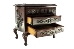 Rosewood jewelry box in the shape of a chest of drawers with silver fittings