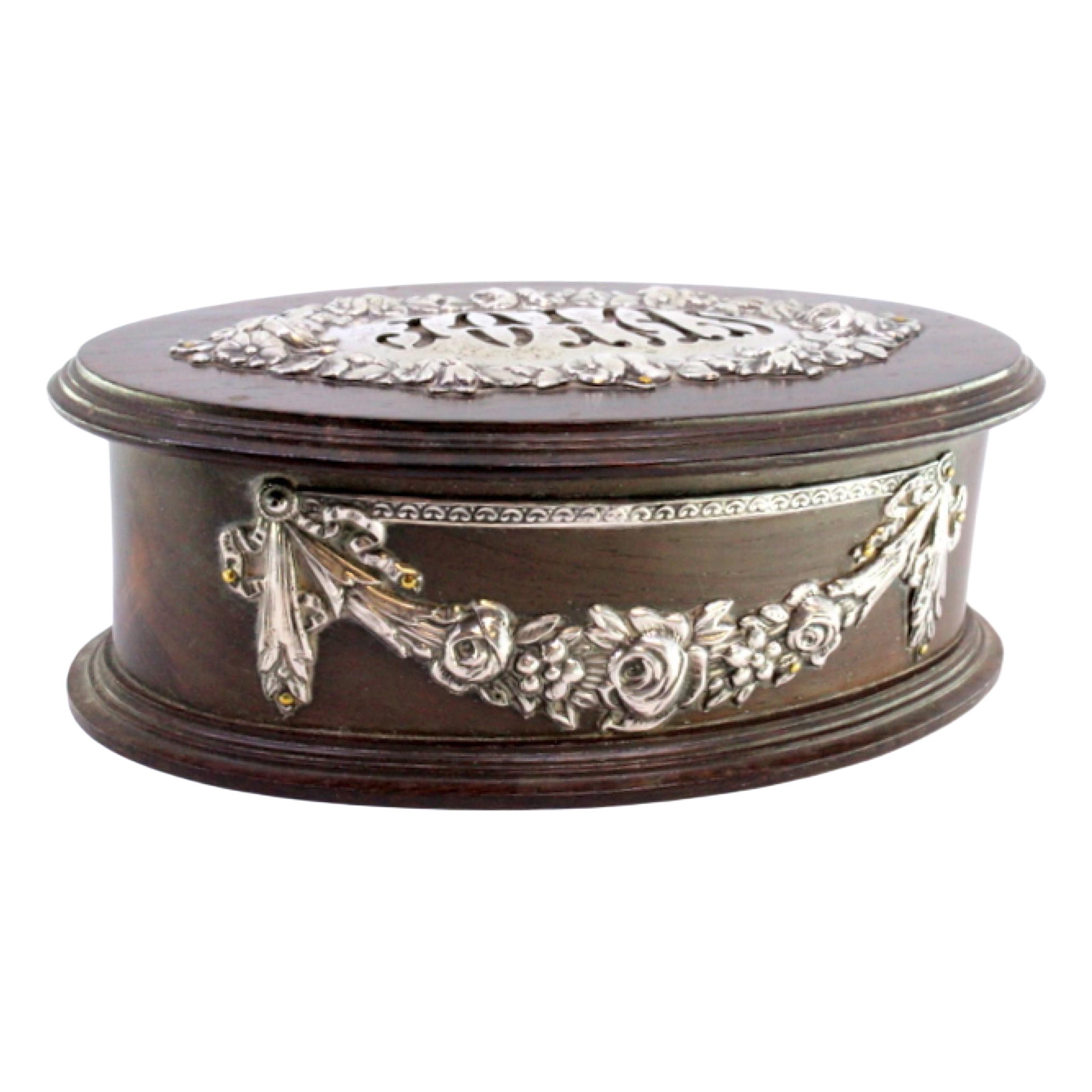 Rosewood jewelry box with lined interior and silver lid and casing appliqués
