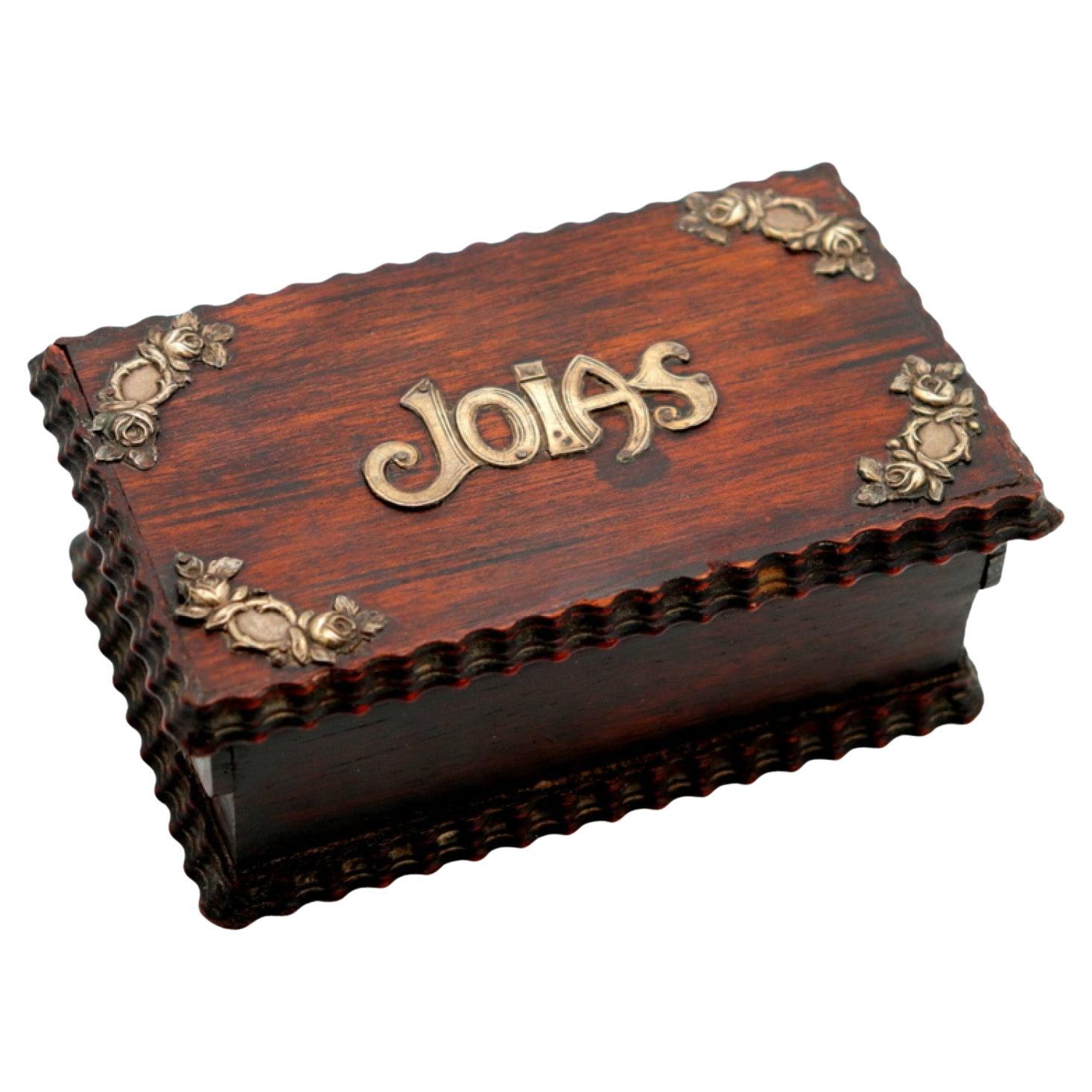 Rosewood jewelry box with silver appliqués and red velvet interior