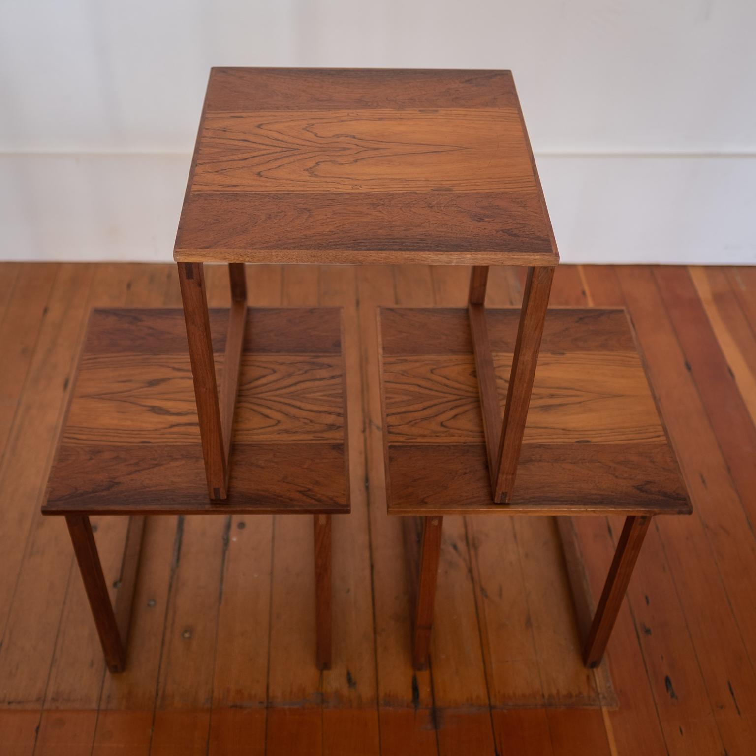 Set of three interlocking nesting tables in rosewood. Beautiful bookmatched rosewood across all three tops. Designed by Kai Kristiansen. Denmark 1960s.