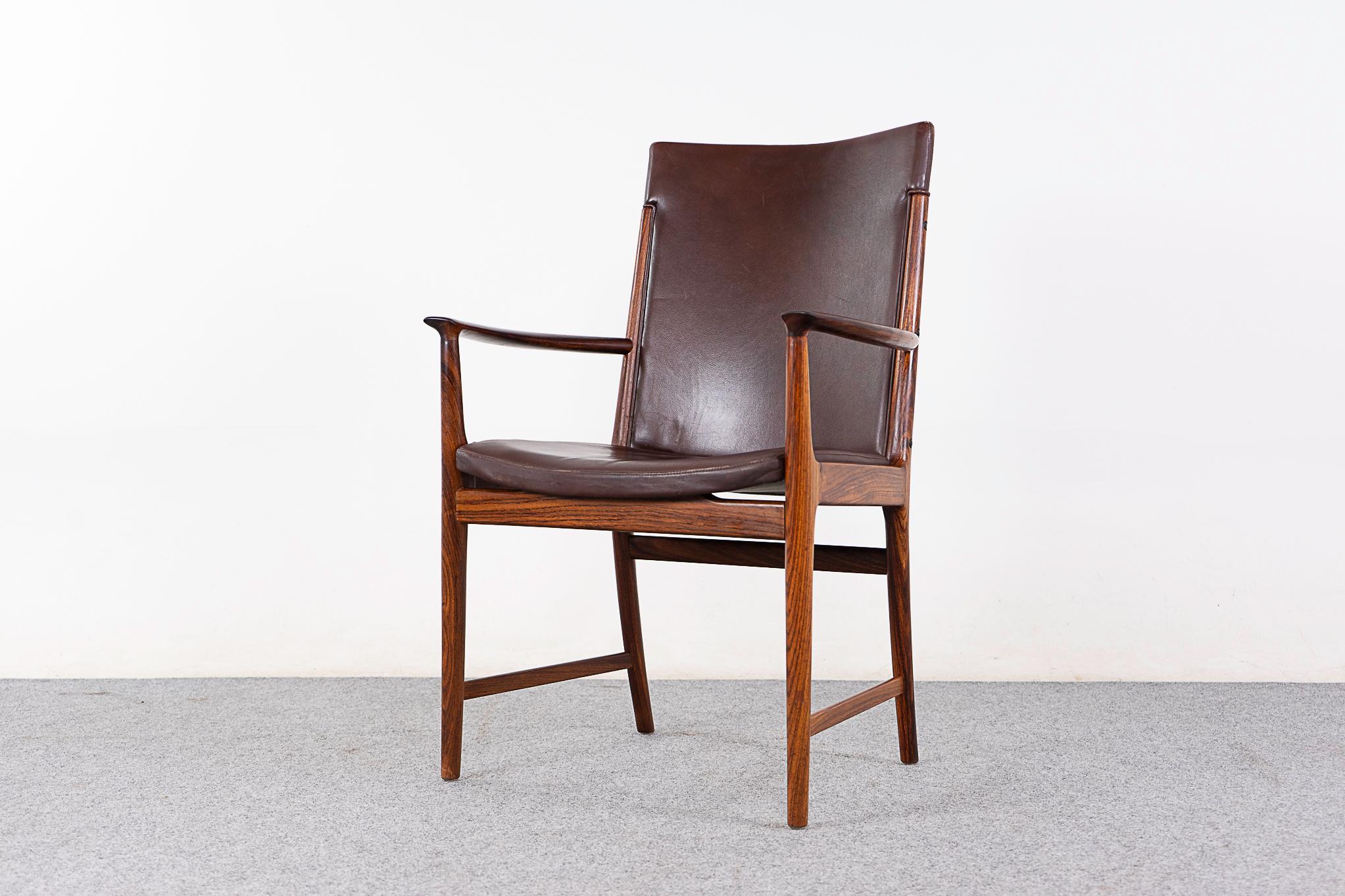 Rosewood & leather Danish arm chair by Kai Lyngfeldt Larsen, circa 1960's. Stunning solid wood frame with upright upholstered back, a very comfortable sit! Elegant, sculptural frame with bowed arms, and many subtle details! 