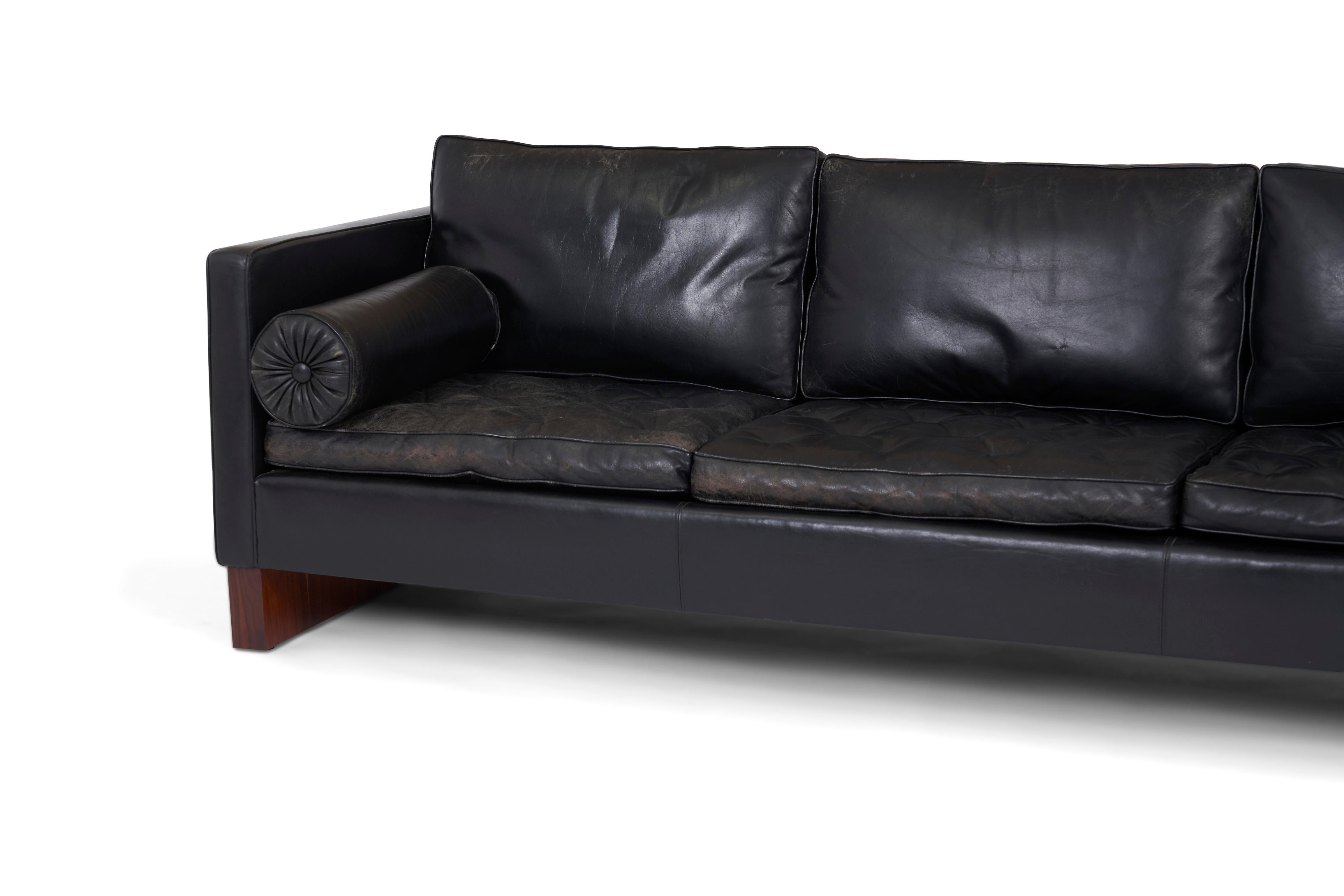 Rare Ludwig Mies van der Rohe designed sofa. Designed by Mies in Germany, 1930, produced by Knoll in 1960. Refinished rosewood bases with original black leather upholstery.
