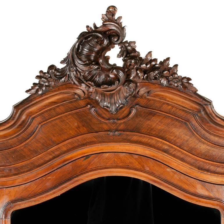 An impressive, carved rosewood, triple-door, Louis XV-Revival armoire, with dramatically-carved top details and legs, having three sections each with several adjustable shelves, circa 1880.

Completely disassembles for transporting.





    