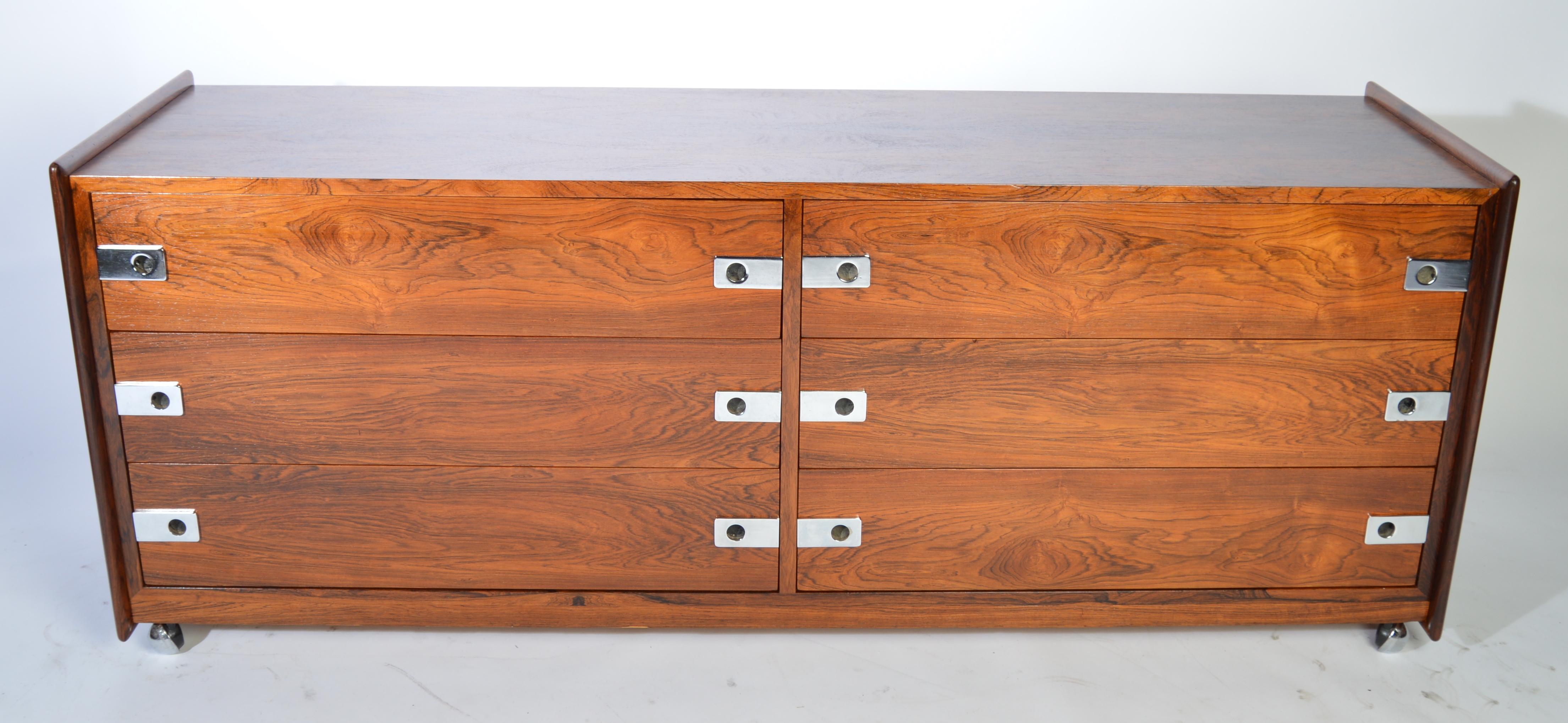 Brazilian rosewood low dresser by Inter-Continental Design Ltd.-Canada on original stainless steel casters.
circa 1970.
Stunning grain throughout.
Beautiful condition. Masterfully refinished.