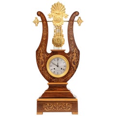 Pendule lyre en marqueterie de bois de rose et ormolu avec pendule à mystère:: Henri Marc 1850