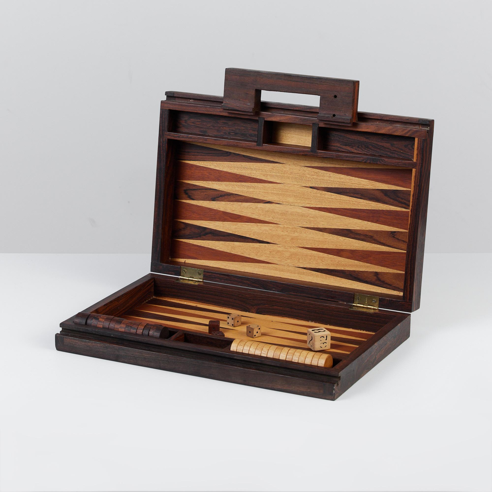 A modernist backgammon set by US-born, Mexico-based designer Don Shoemaker for his company Señal. This portable set includes the game board, which folds up into a carrying case, checkers, rolling dice, and doubling dice. Made from local hardwood